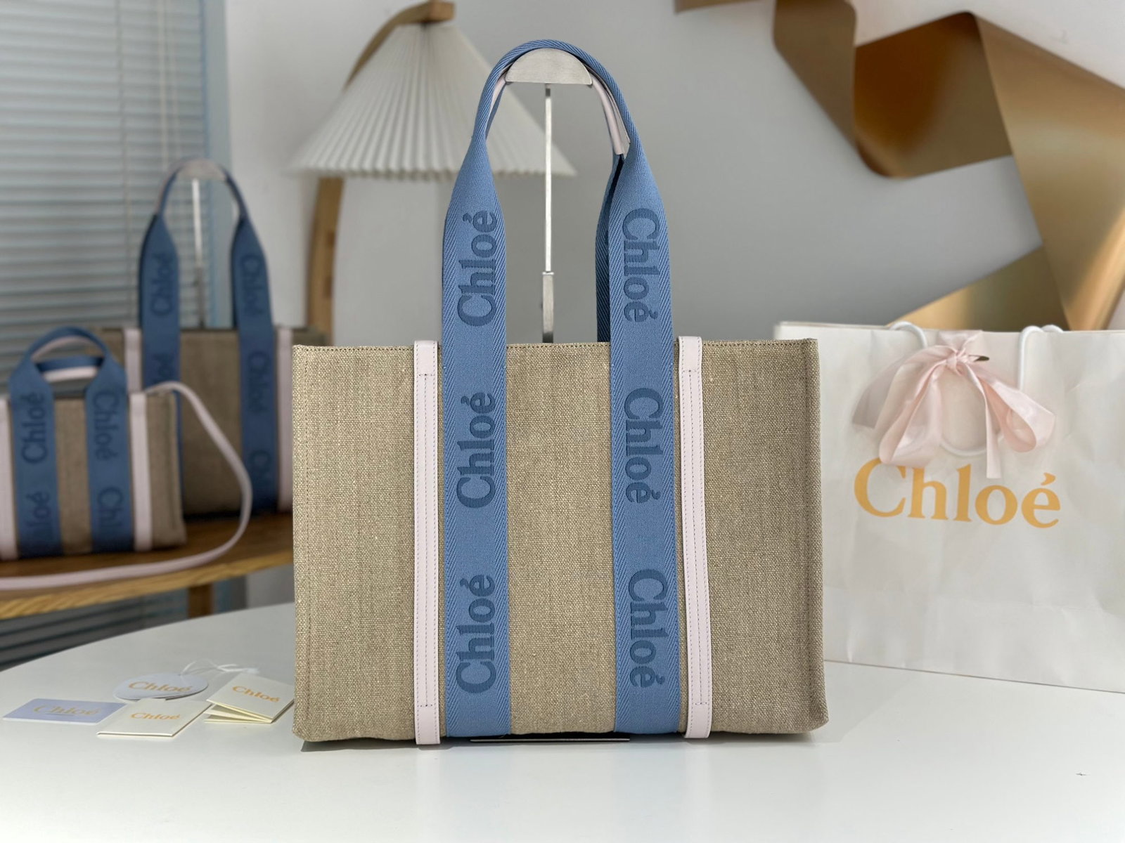 Chloe woody Tote: We offer FREE SHIPPING for both domestic and international clients who bid over $500. The Chloe Woody Tote in creamy pink with blue webbing is absolutely gorgeous. The bag is made of eco-friendly, dur