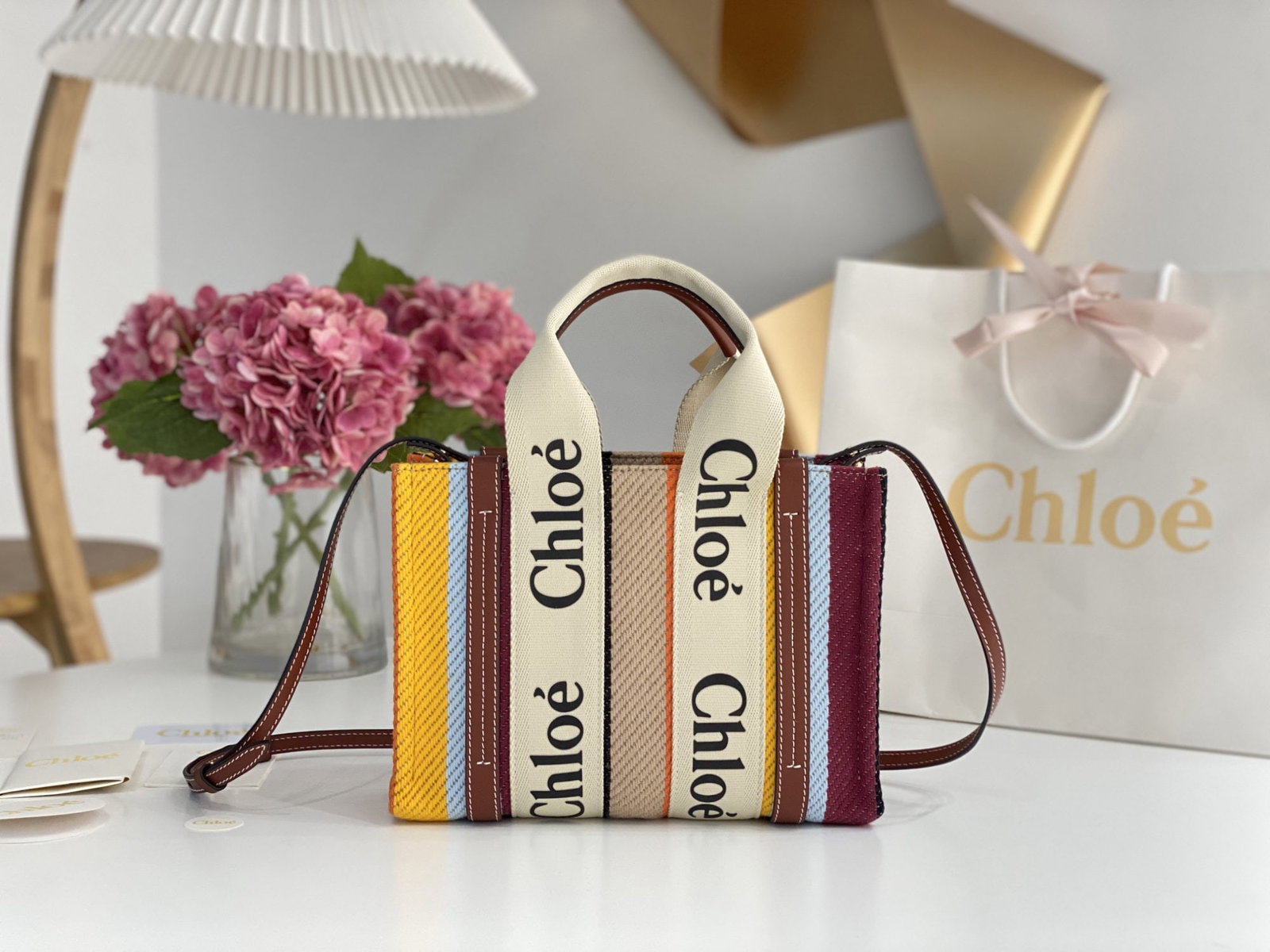 Chloe Woody: We offer FREE SHIPPING for both domestic and international clients who bid over $500. This Chloe Rainbow Woody Tote bag features a beautiful rainbow color scheme and is crafted from linen striped cott