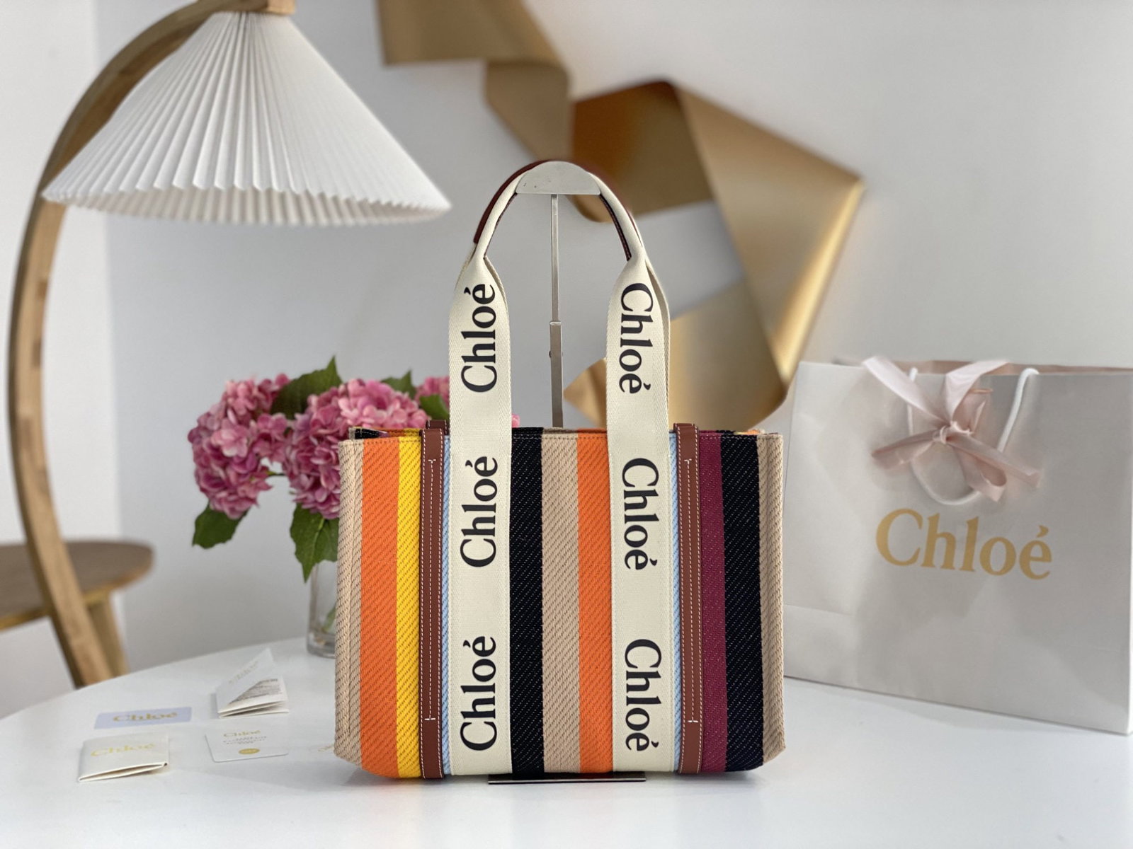 Chloe Woody: We offer FREE SHIPPING for both domestic and international clients who bid over $500. The Chloe Rainbow Woody Tote bag boasts beautiful rainbow colors and is crafted from linen striped cotton, giving 