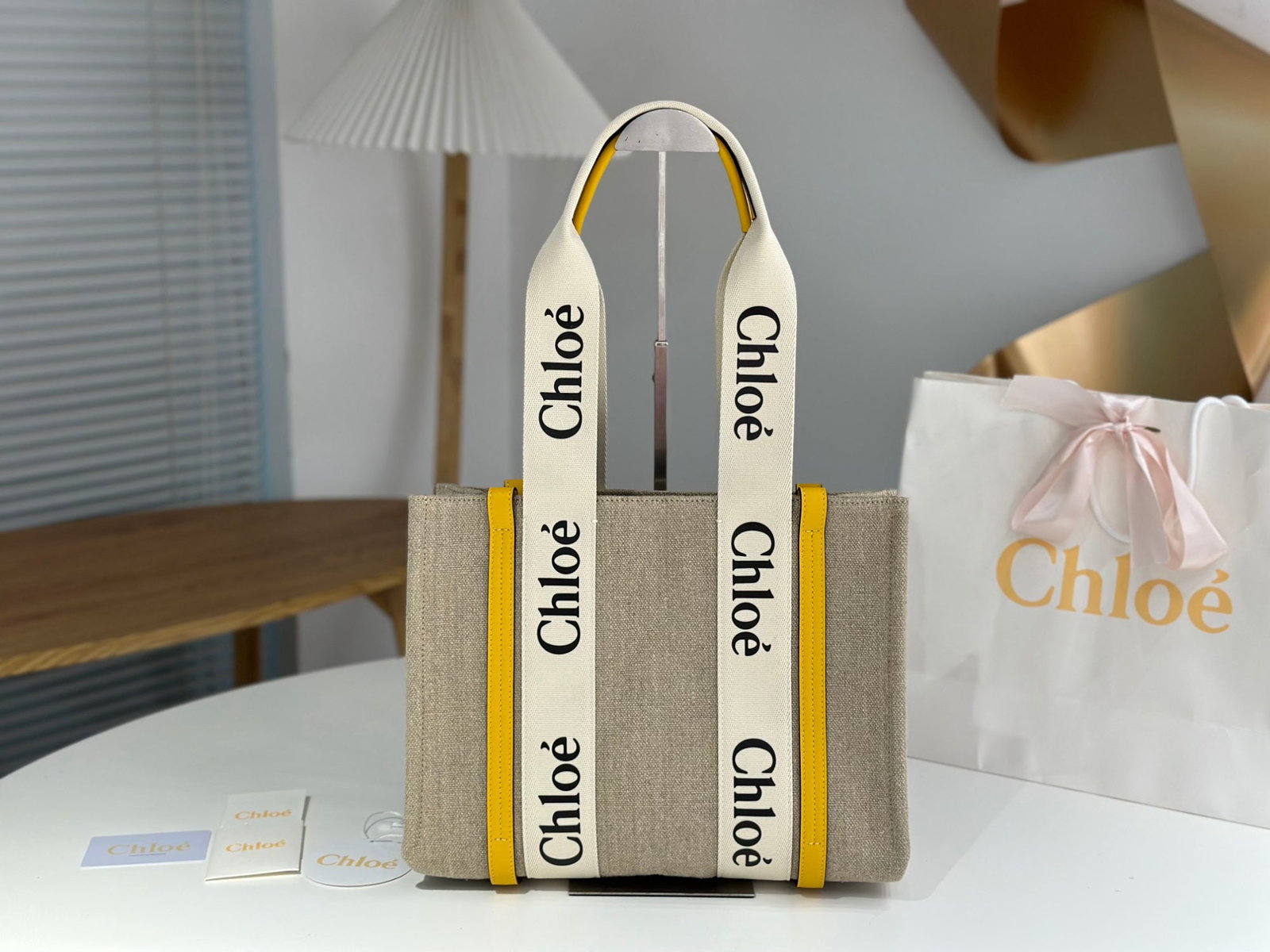 Chloe Woody: We offer FREE SHIPPING for both domestic and international clients who bid over $500. This cream-yellow Chloe Woody tote bag features the classic Woody series letter ribbon. It's crafted from eco-frie