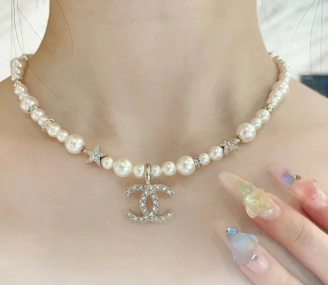 Chanel necklace (collarbone chain): We offer FREE SHIPPING for both domestic and international clients who bid over $500. This Chanel 100th Anniversary Pearl Necklace is exquisitely crafted and beautiful. The oval logo on the back is cl