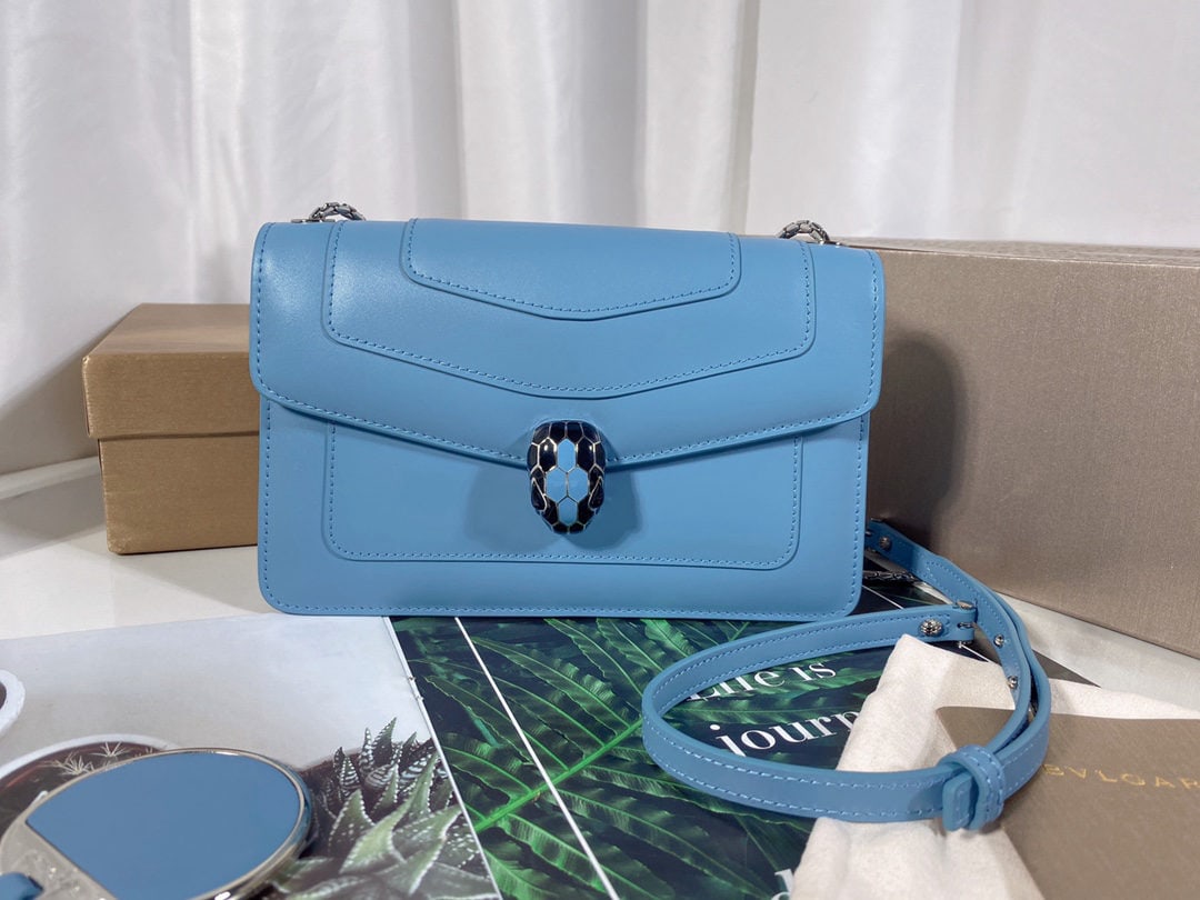 Bvlgari: We offer FREE SHIPPING for both domestic and international clients who bid over $500. This Bvlgari Niagara Sapphire Blue calfskin bag features a snake head clasp, accented with black and alluring blac