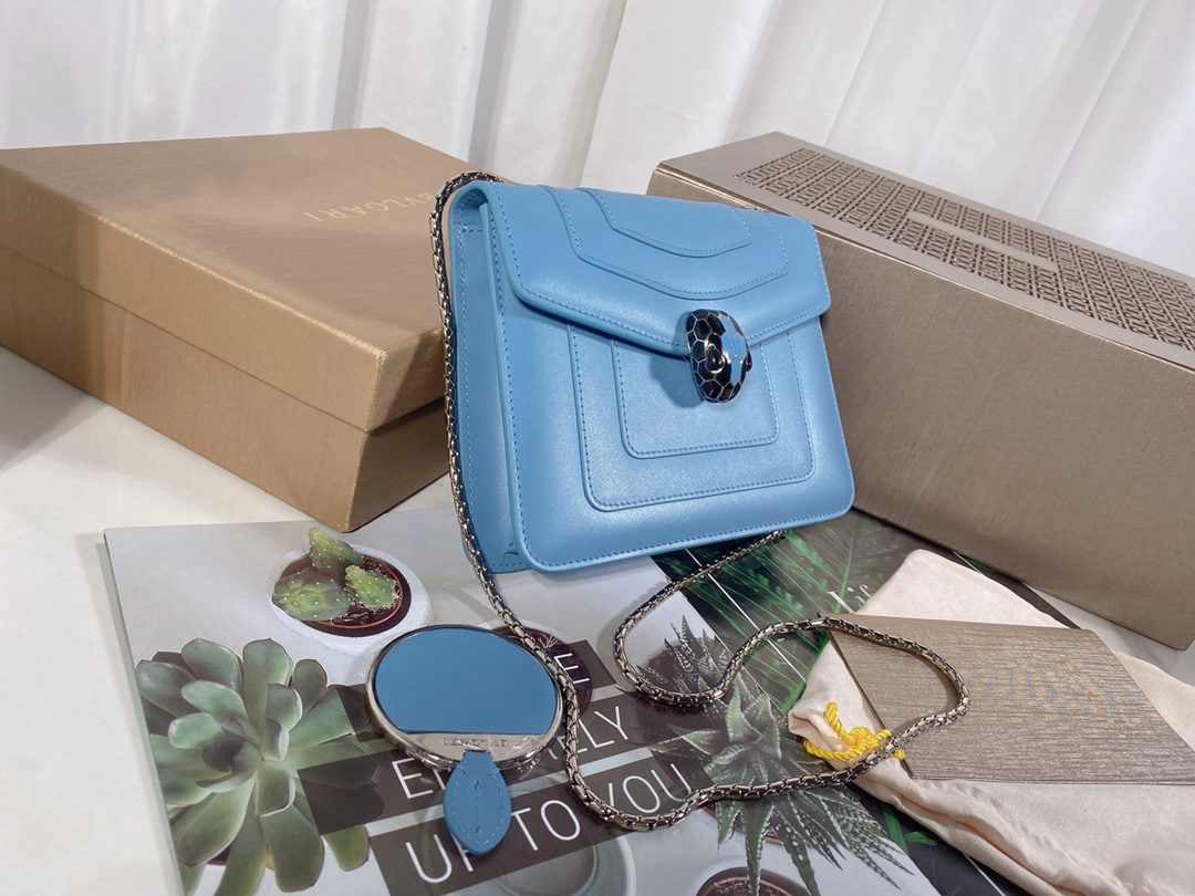 Bvlgari: We offer FREE SHIPPING for both domestic and international clients who bid over $500. This Bvlgari Niagara sapphire blue calfskin bag features the iconic snakehead clasp, adorned with black and Niagar