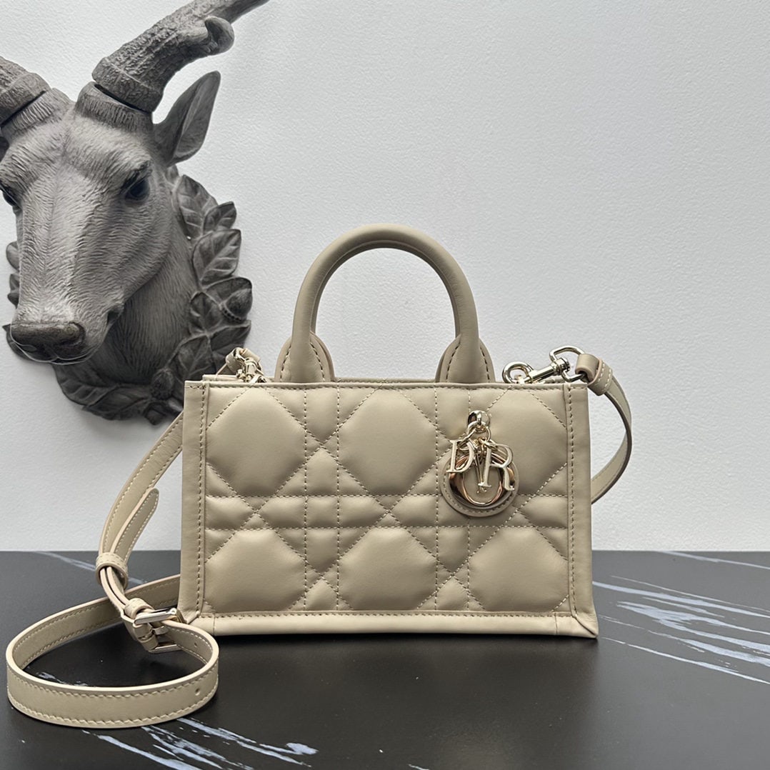 Christian Dior Book Tote: We offer FREE SHIPPING for both domestic and international clients who bid over $500. The mini Dior Book Tote bag is a classic original design by Dior Creative Director Maria Grazia Chiuri. Crafted fr