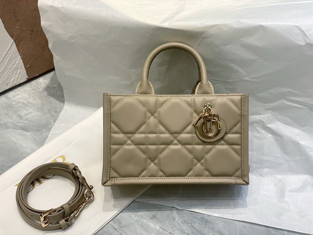 Christian Dior Book Tote: We offer FREE SHIPPING for both domestic and international clients who bid over $500. The Dior Book Tote mini tote bag, in beige-brown, is a classic original design by Dior's Creative Director, Maria 