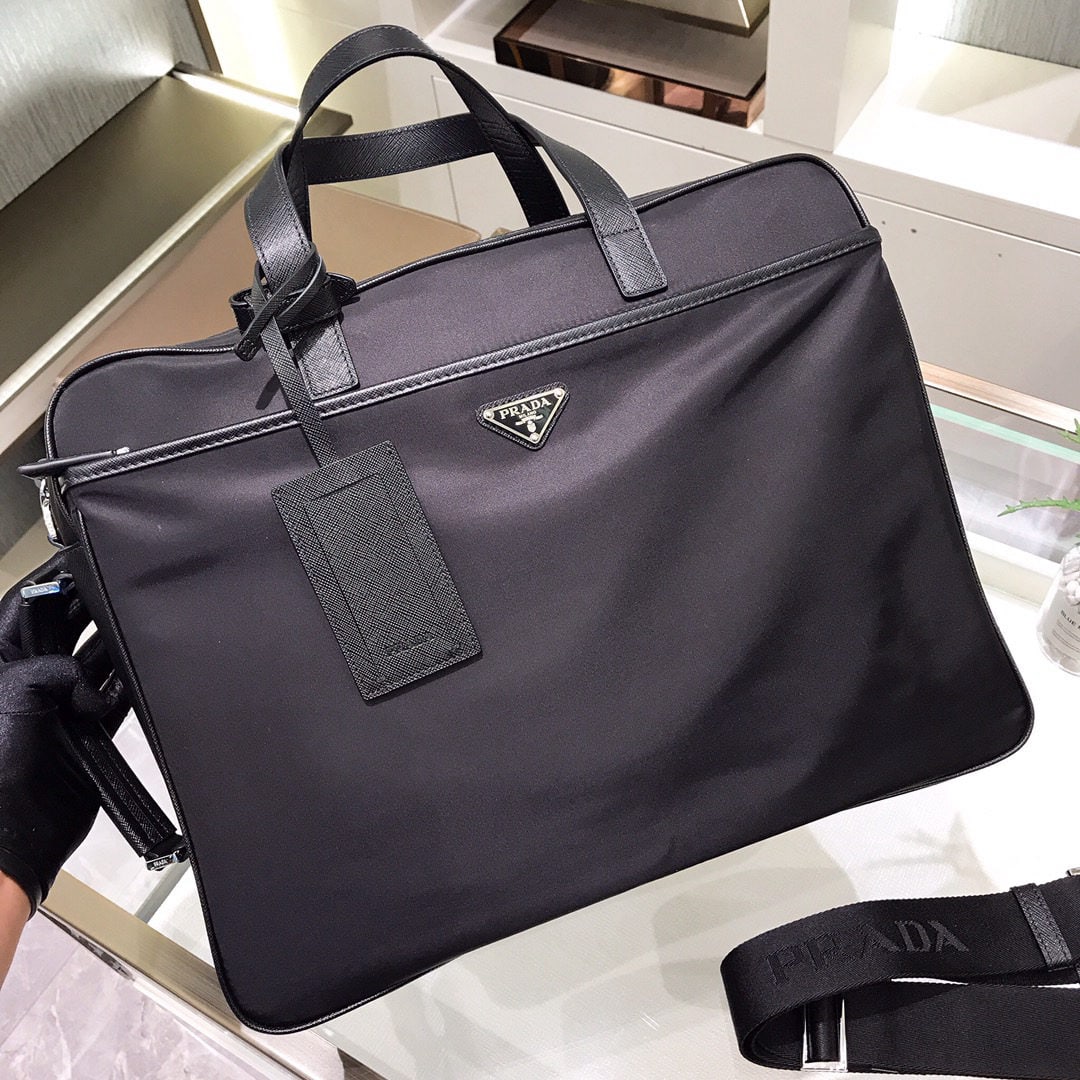 PRADA Multifunctional Briefcase/Backpack: We offer FREE SHIPPING for both domestic and international clients who bid over $500. This multi-functional briefcase/backpack is made of imported nylon and Saffiano cross-grain leather. It features d