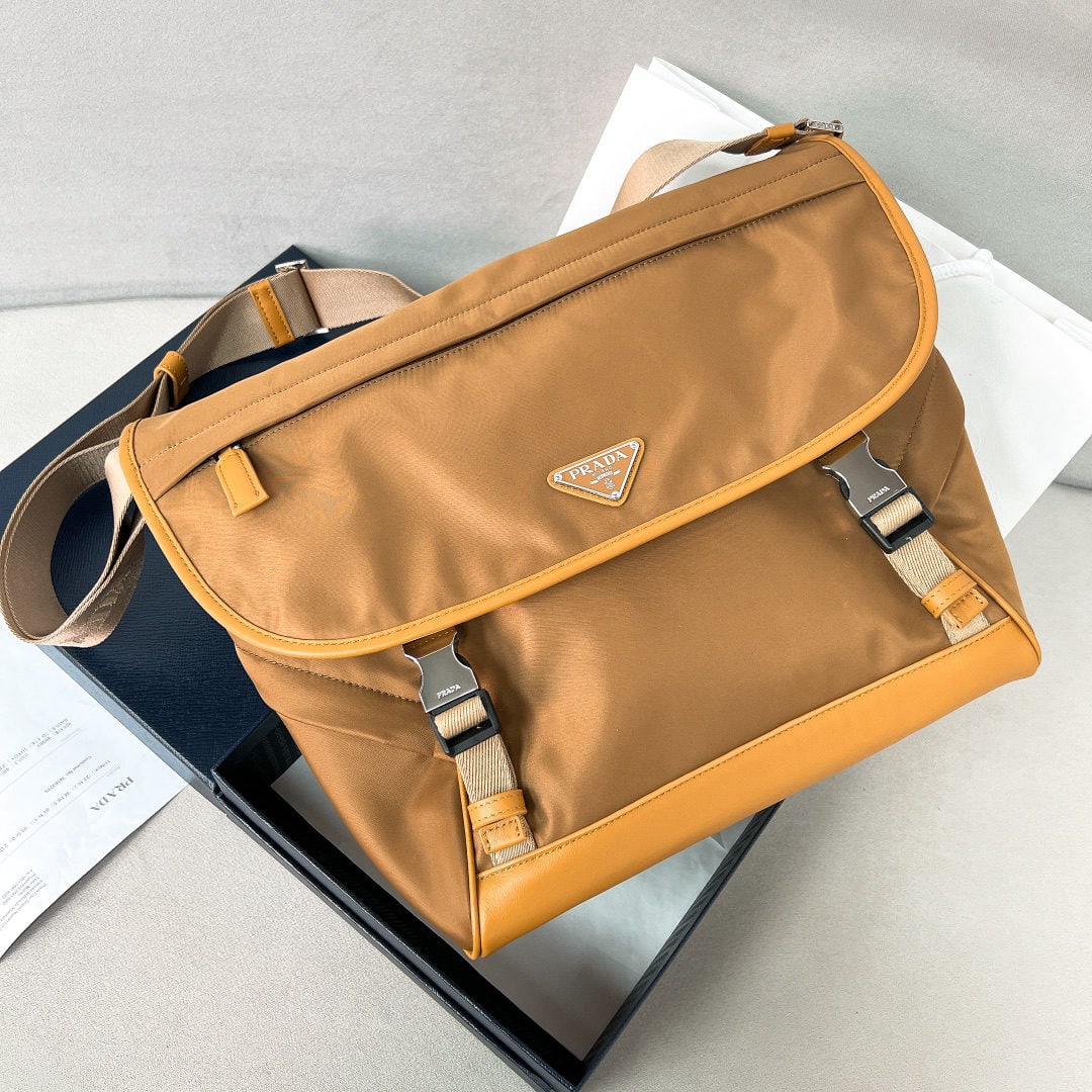 PRADA messenger bag: We offer FREE SHIPPING for both domestic and international clients who bid over $500. This messenger bag is designed from Re-Nylon recycled nylon fabric and features contrasting calfskin leather. It