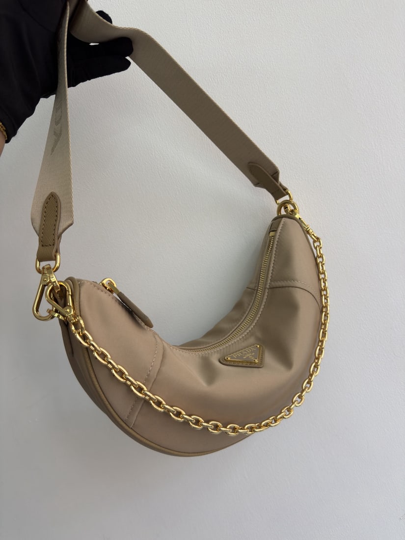 PRADA Crescent Bag Multifunctional: We offer FREE SHIPPING for both domestic and international clients who bid over $500. The Crescent Bag, a multi-functional Re-Nylon handbag, is crafted from recycled nylon. Exquisite and versatile,
