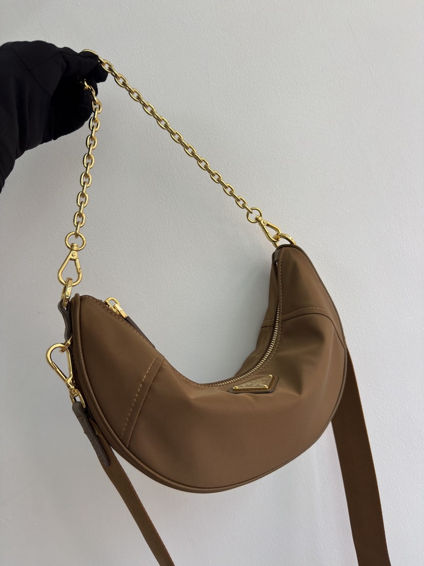 PRADA Crescent Bag Multifunctional: We offer FREE SHIPPING for both domestic and international clients who bid over $500. The Crescent Bag, a multi-functional Re-Nylon handbag, is crafted from recycled nylon. Exquisite and versatile,