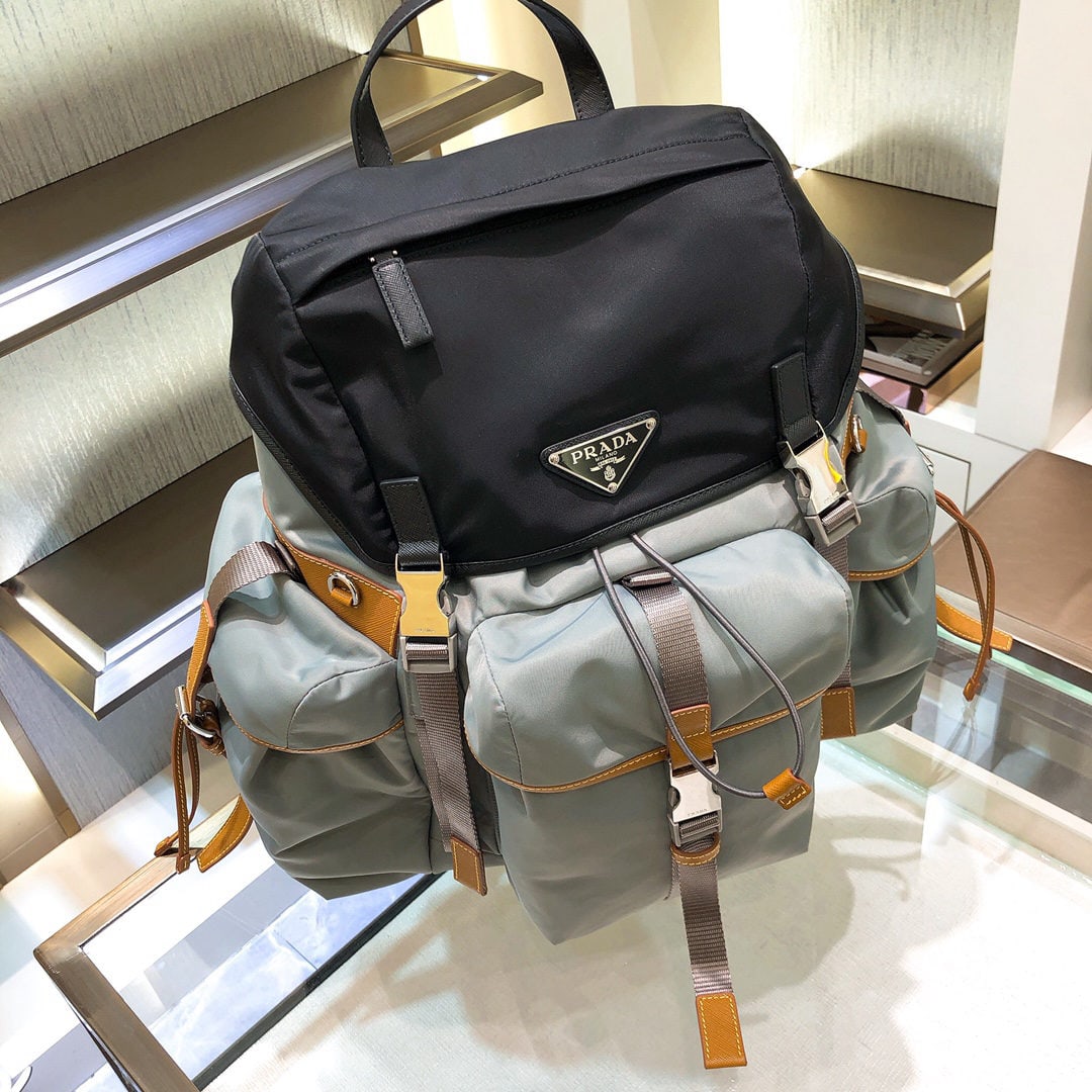 PRADA backpack: We offer FREE SHIPPING for both domestic and international clients who bid over $500. This backpack is crafted from fabric trimmed with Saffiano leather, showcasing a design that combines functionalit