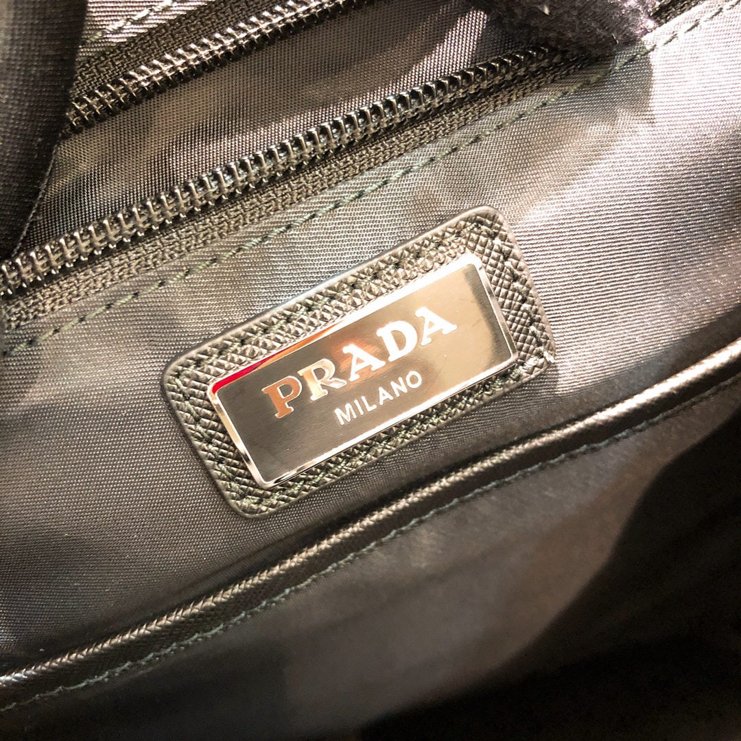 PRADA backpack: We offer FREE SHIPPING for both domestic and international clients who bid over $500. This backpack is crafted from fabric trimmed with Saffiano leather, showcasing a design that combines