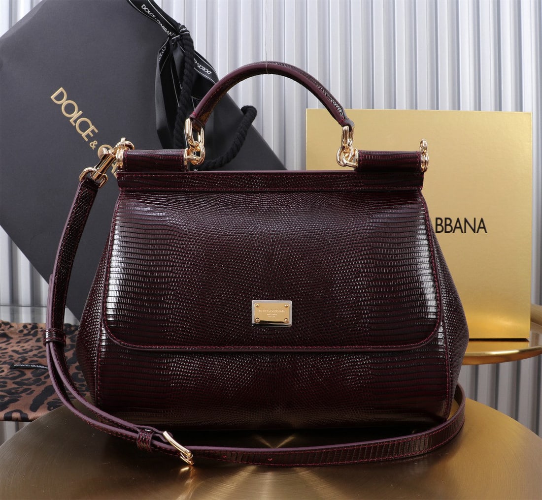 Dolce & Gabbana: We offer FREE SHIPPING for both domestic and international clients who bid over $500. The Dolce & Gabbana Sicily lizard-patterned gold-buckled lizard-patterned bag, a signature piece from the brand, i