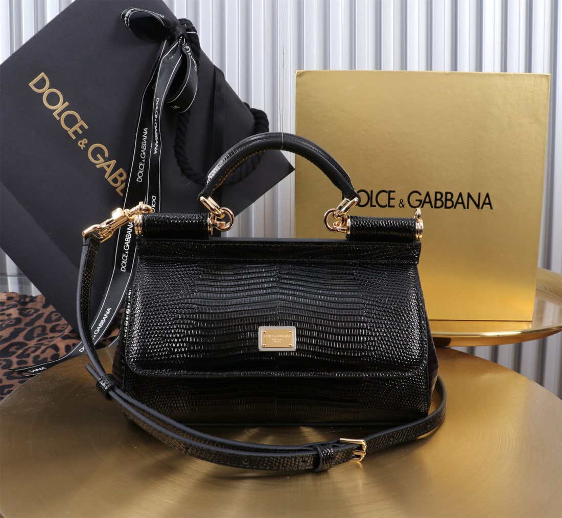 Dolce & Gabbana: We offer FREE SHIPPING for both domestic and international clients who bid over $500. The Dolce & Gabbana Sicily lizard-patterned gold-buckled lizard-patterned bag, a signature design, is now presente