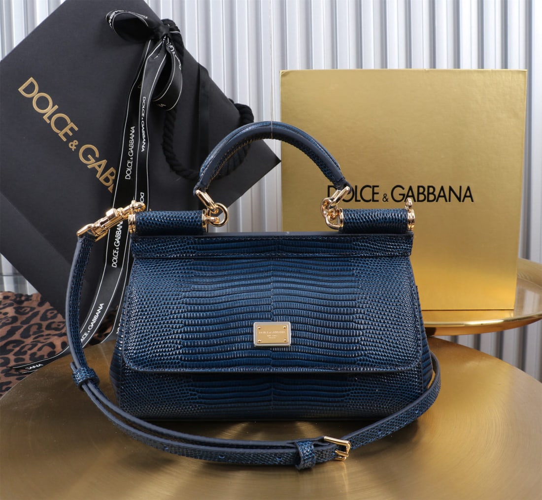 Dolce & Gabbana: We offer FREE SHIPPING for both domestic and international clients who bid over $500. The Dolce & Gabbana Sicily lizard-patterned gold-buckled lizard-patterned bag, a signature design, is now presente