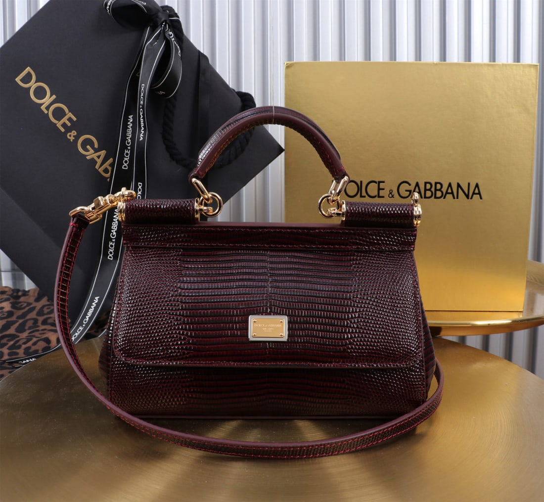 Dolce & Gabbana: We offer FREE SHIPPING for both domestic and international clients who bid over $500. The Dolce & Gabbana Sicily lizard-patterned gold-buckled lizard-patterned bag, a signature design, is now presente