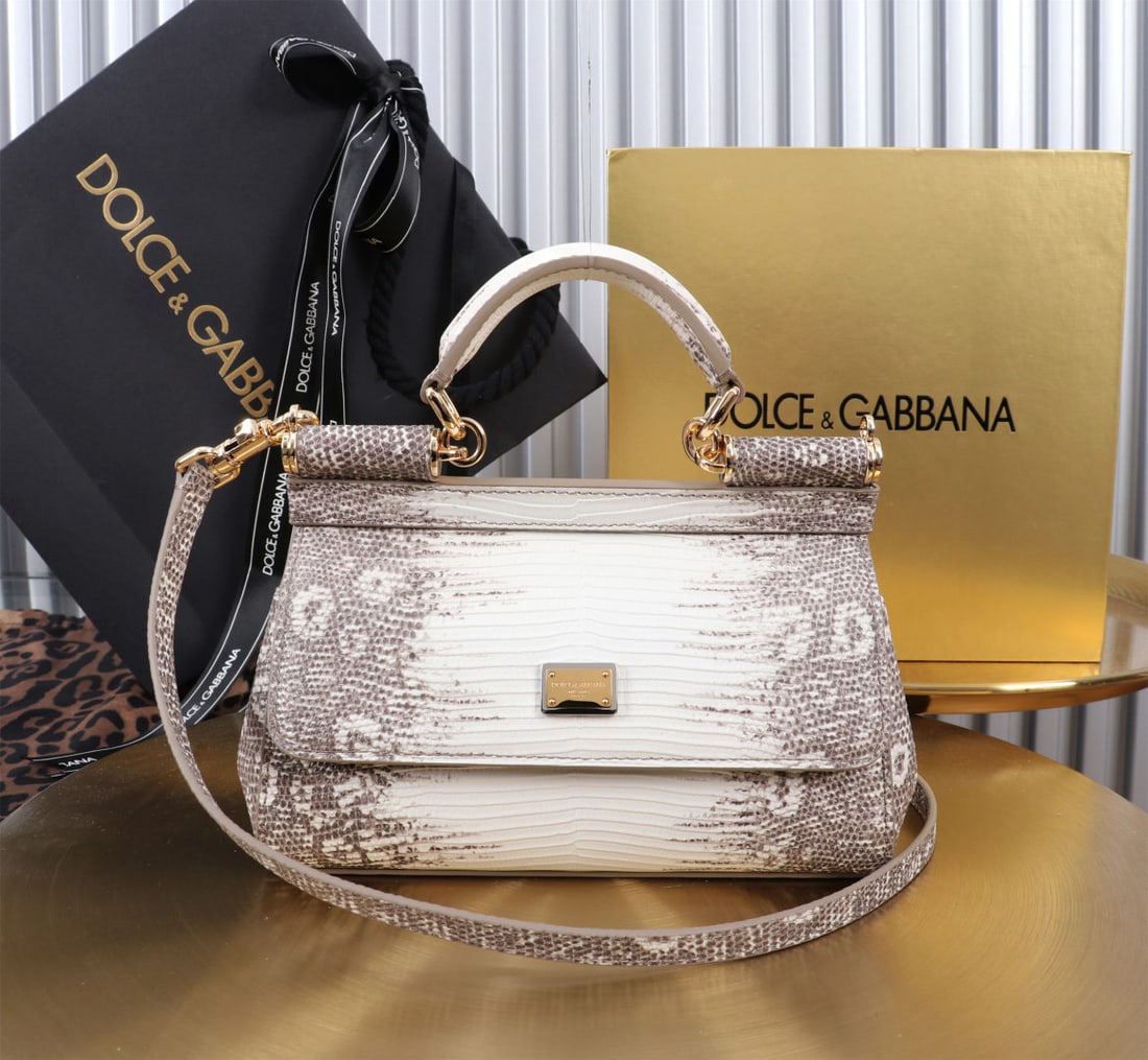 Dolce & Gabbana: We offer FREE SHIPPING for both domestic and international clients who bid over $500. The Dolce & Gabbana Sicily lizard-print gold-buckle design, a signature piece from the brand, is now presented in 