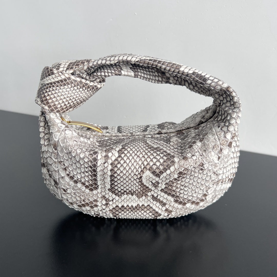Bottega Veneta Jodie: We offer FREE SHIPPING for both domestic and international clients who bid over $500. The Bottega Veneta Jodie python skin evening bag exudes a regal aura, making it more than just a bag; it's a symbo