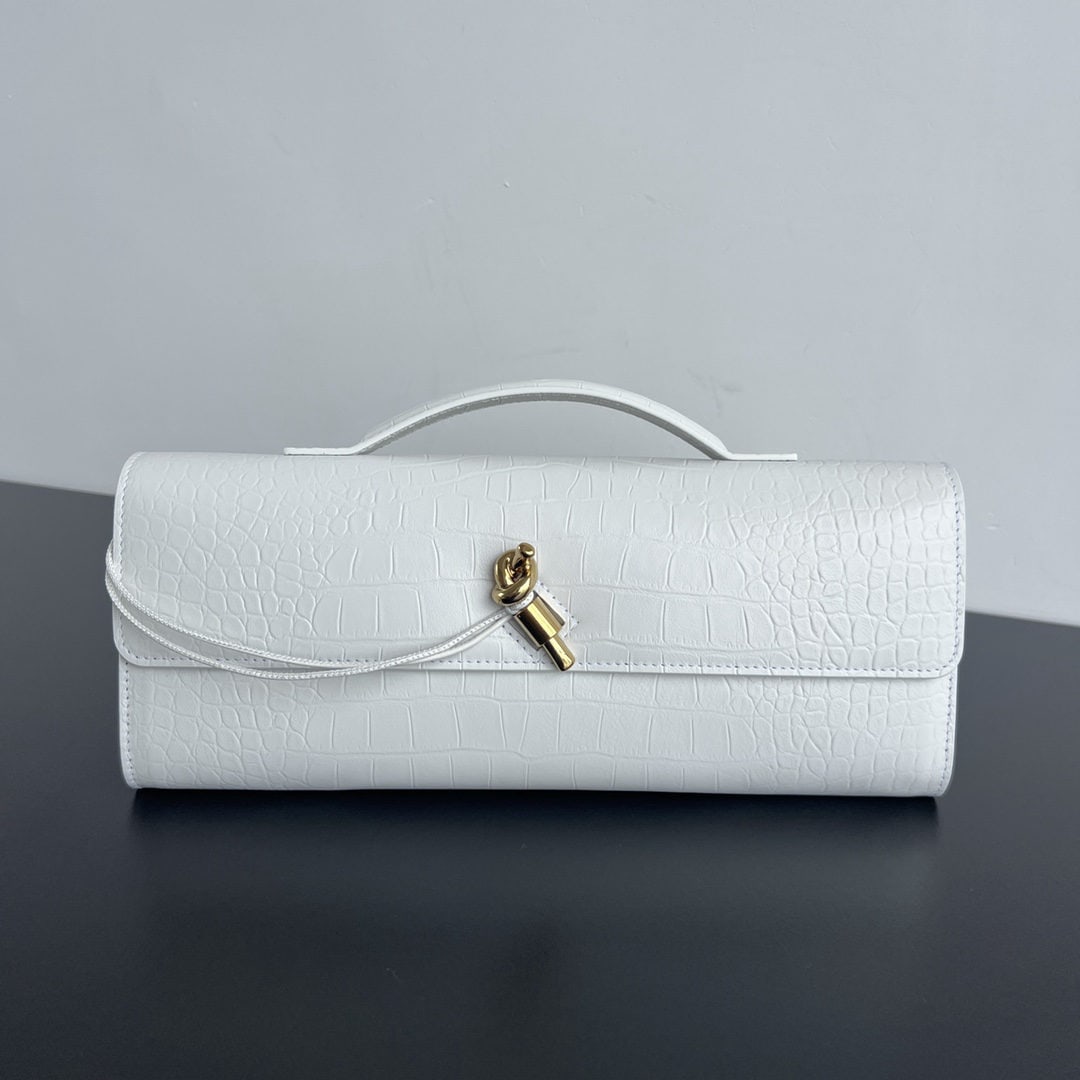 Bottega Veneta: We offer FREE SHIPPING for both domestic and international clients who bid over $500. This Bottega Veneta faux crocodile-embossed long clutch features a handle. The design exudes sophistication and hi