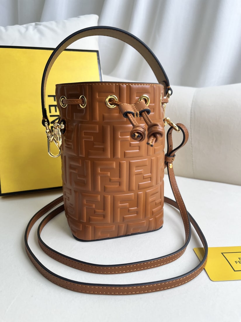 Fendi Mon Tresor: We offer FREE SHIPPING for both domestic and international clients who bid over $500. Brown embossed Mon Tresor mini bucket bag in light blue leather. Features a drawstring closure and Fendi logo hard