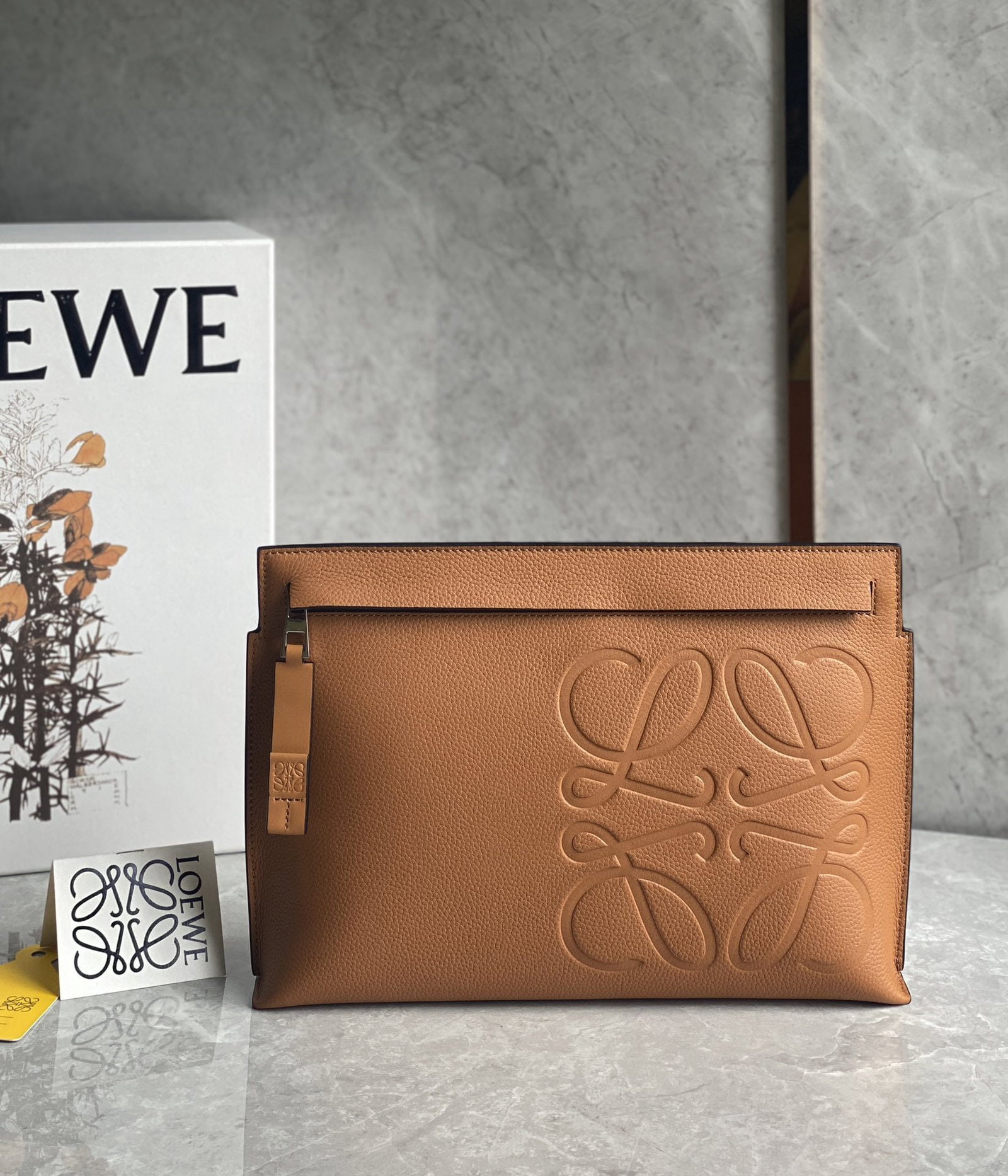 LOEWE Textured T-shirt: We offer FREE SHIPPING for both domestic and international clients who bid over $500. The LOEWE Grained T Pouch handbag is crafted from supple grained calfskin, offering a wonderfully luxurious feel.