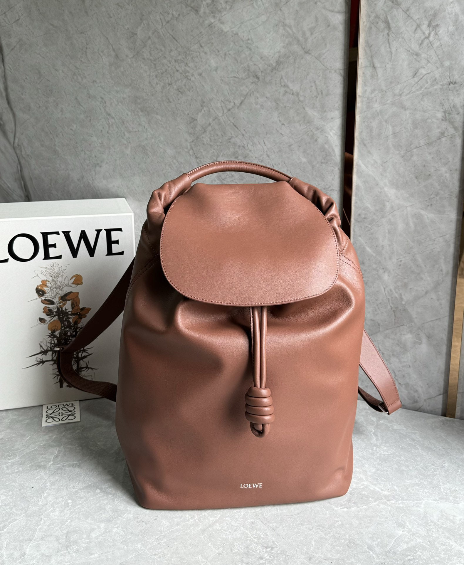 LOEWE: We offer FREE SHIPPING for both domestic and international clients who bid over $500. This LOEWE backpack features a streamlined, practical everyday design, paying homage to the iconic knotted detail