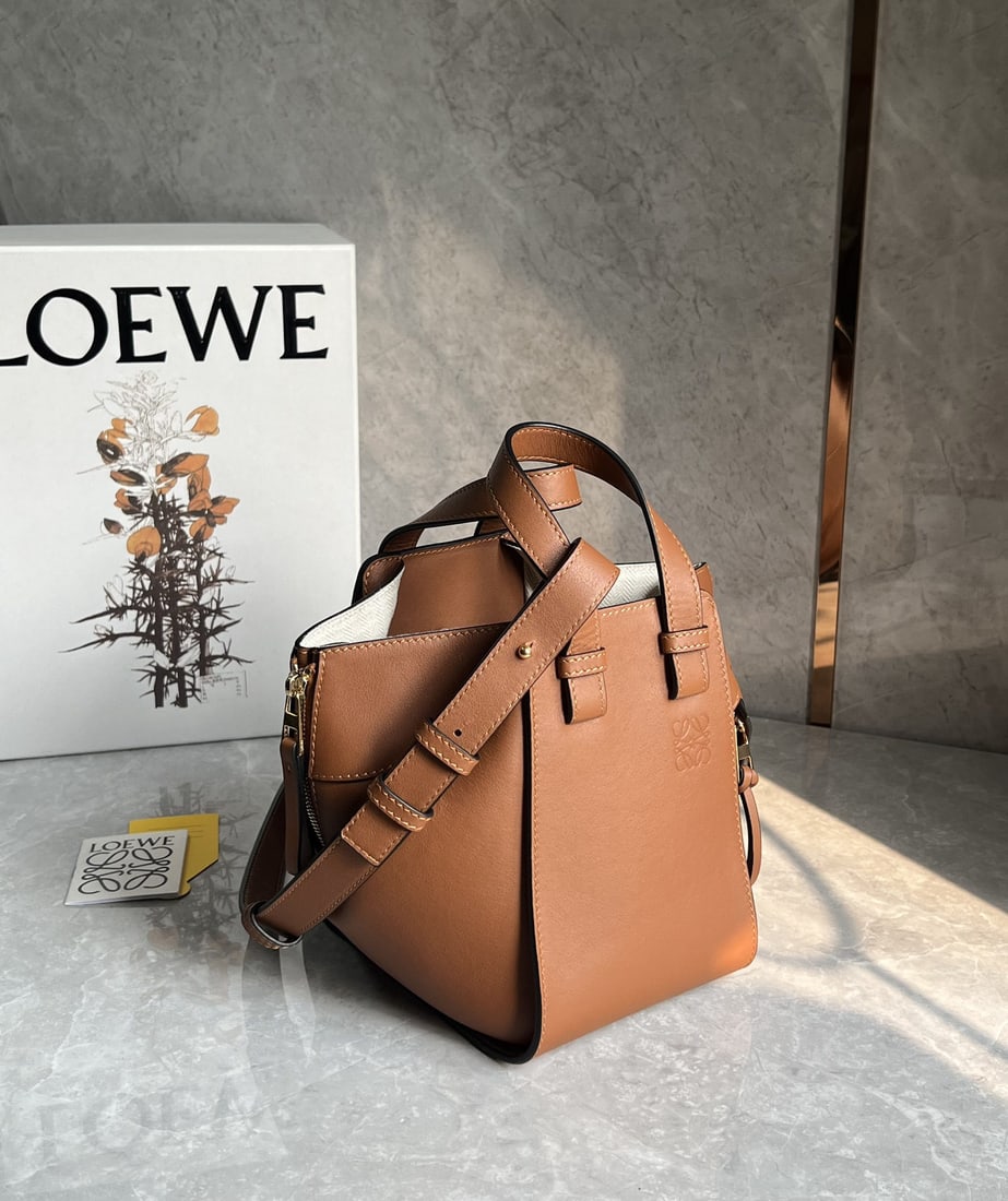 LOEWE: We offer FREE SHIPPING for both domestic and international clients who bid over $500. LOEWE's caramel-colored Hammock bag is a fashion "Transformer." It's versatile enough for everyday wear, casual