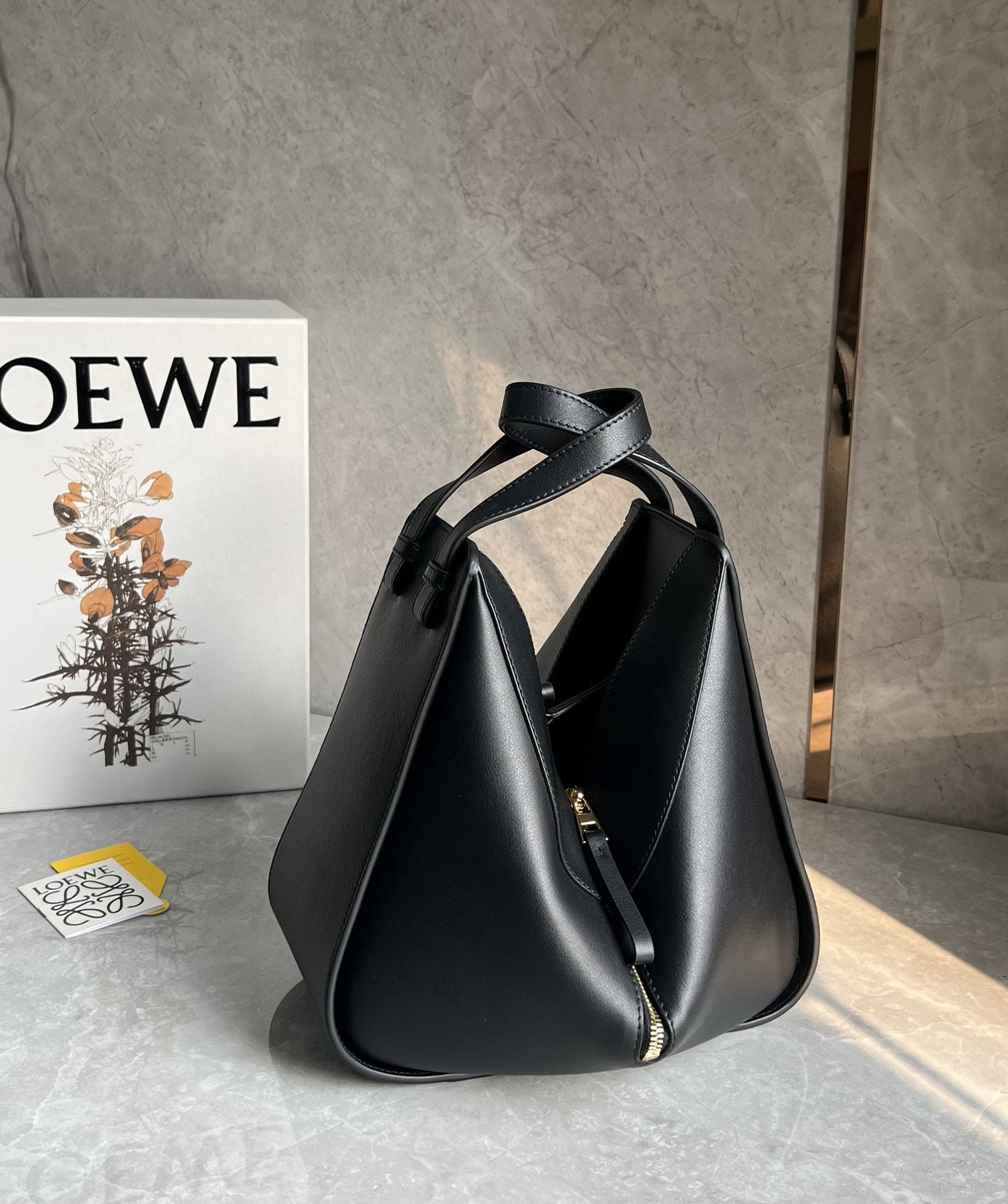 LOEWE: We offer FREE SHIPPING for both domestic and international clients who bid over $500. LOEWE's classic black small Hammock bag is a fashion "Transformer." Its innovative and versatile design allows