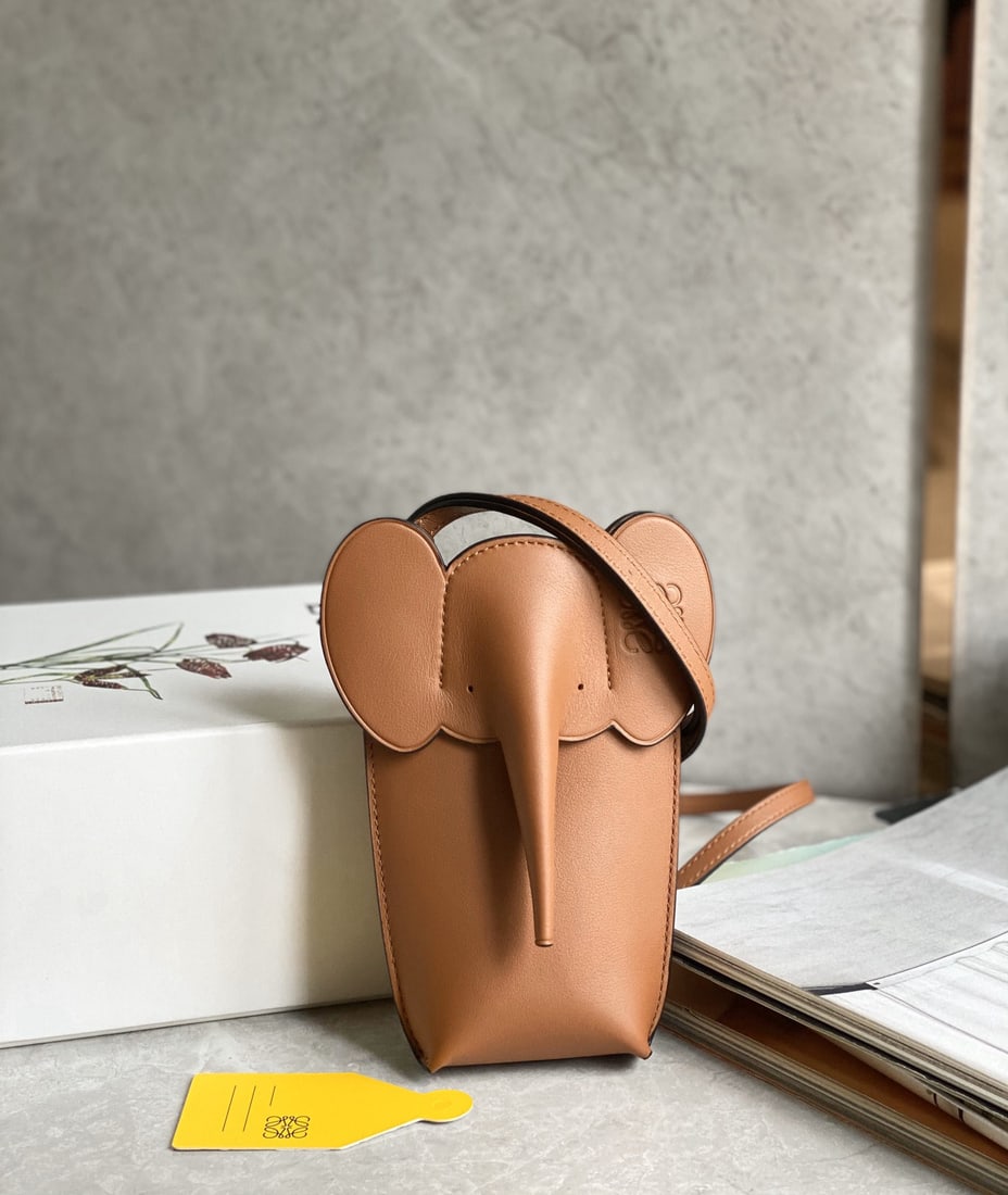 LOEWE: We offer FREE SHIPPING for both domestic and international clients who bid over $500. This adorable elephant phone bag is made of calfskin and can be worn over the shoulder or crossbody. The