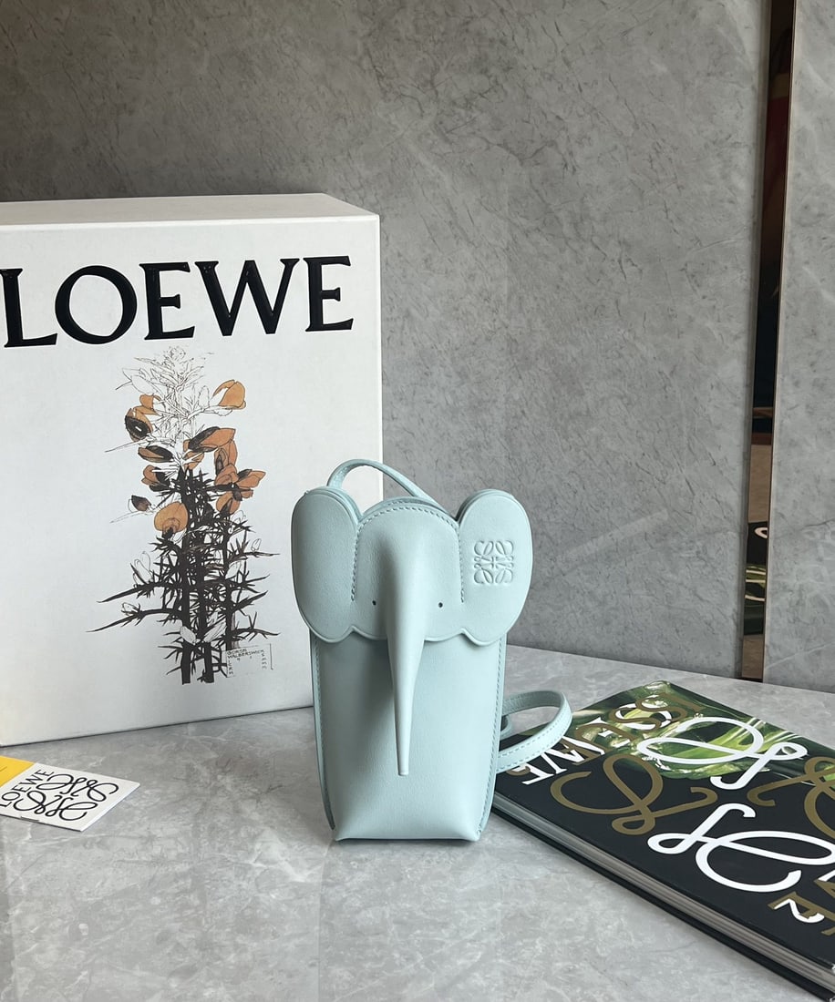 LOEWE: We offer FREE SHIPPING for both domestic and international clients who bid over $500. LOEWE's adorable elephant phone bag is made of calfskin and can be worn over the shoulder or crossbody. The
