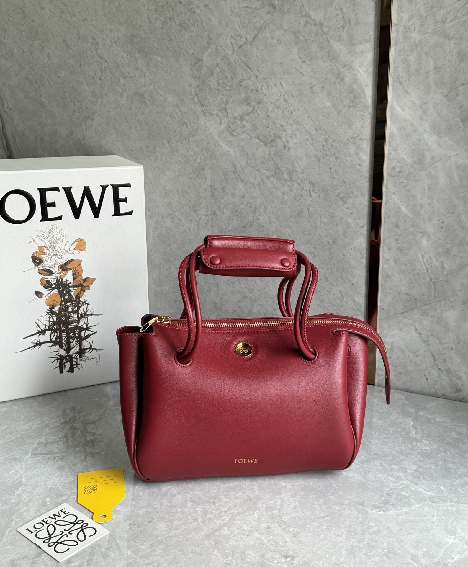 LOEWE: We offer FREE SHIPPING for both domestic and international clients who bid over $500. The LOEWE Small Madrid bag features a soft, structured trapezoidal shape with a gusseted design, adjustable handle
