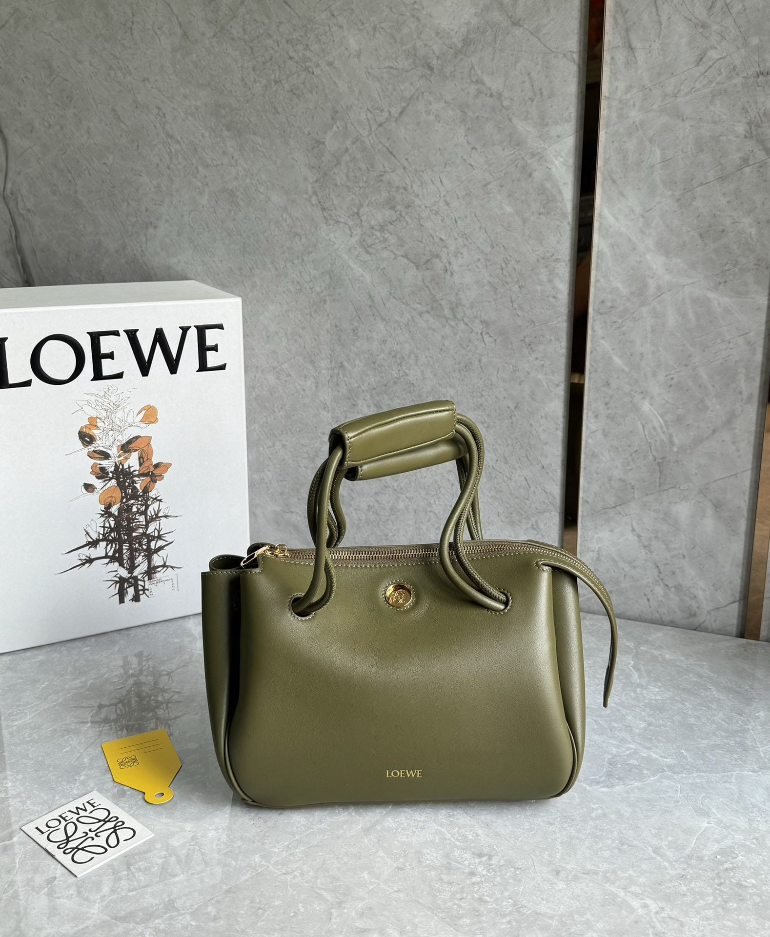 LOEWE: We offer FREE SHIPPING for both domestic and international clients who bid over $500. The LOEWE Small Madrid bag features a soft, structured trapezoidal shape with a gusseted design, adjustable