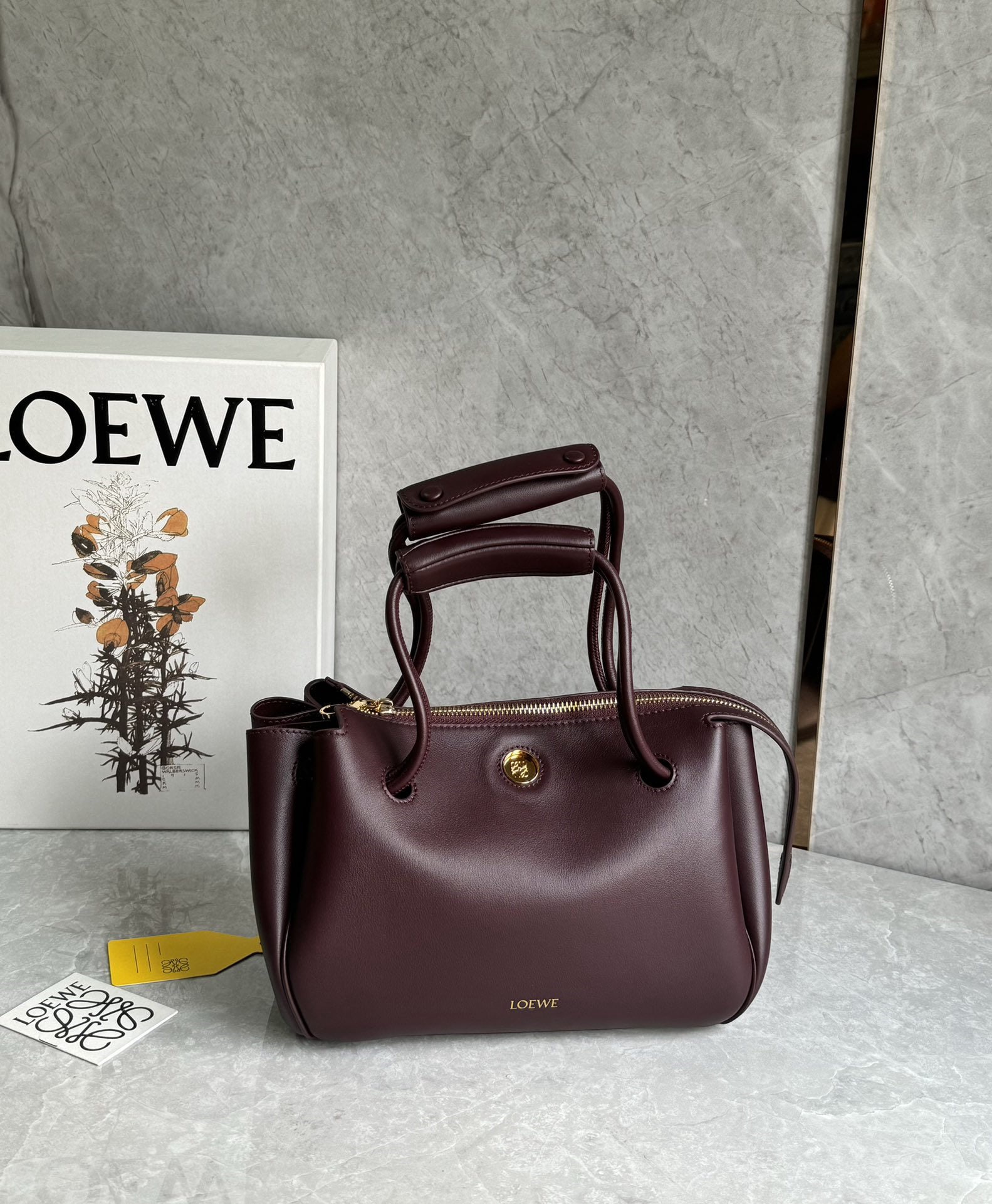 LOEWE: We offer FREE SHIPPING for both domestic and international clients who bid over $500. The LOEWE Small Madrid bag features a soft, structured trapezoidal shape with a gusseted design, adjustable