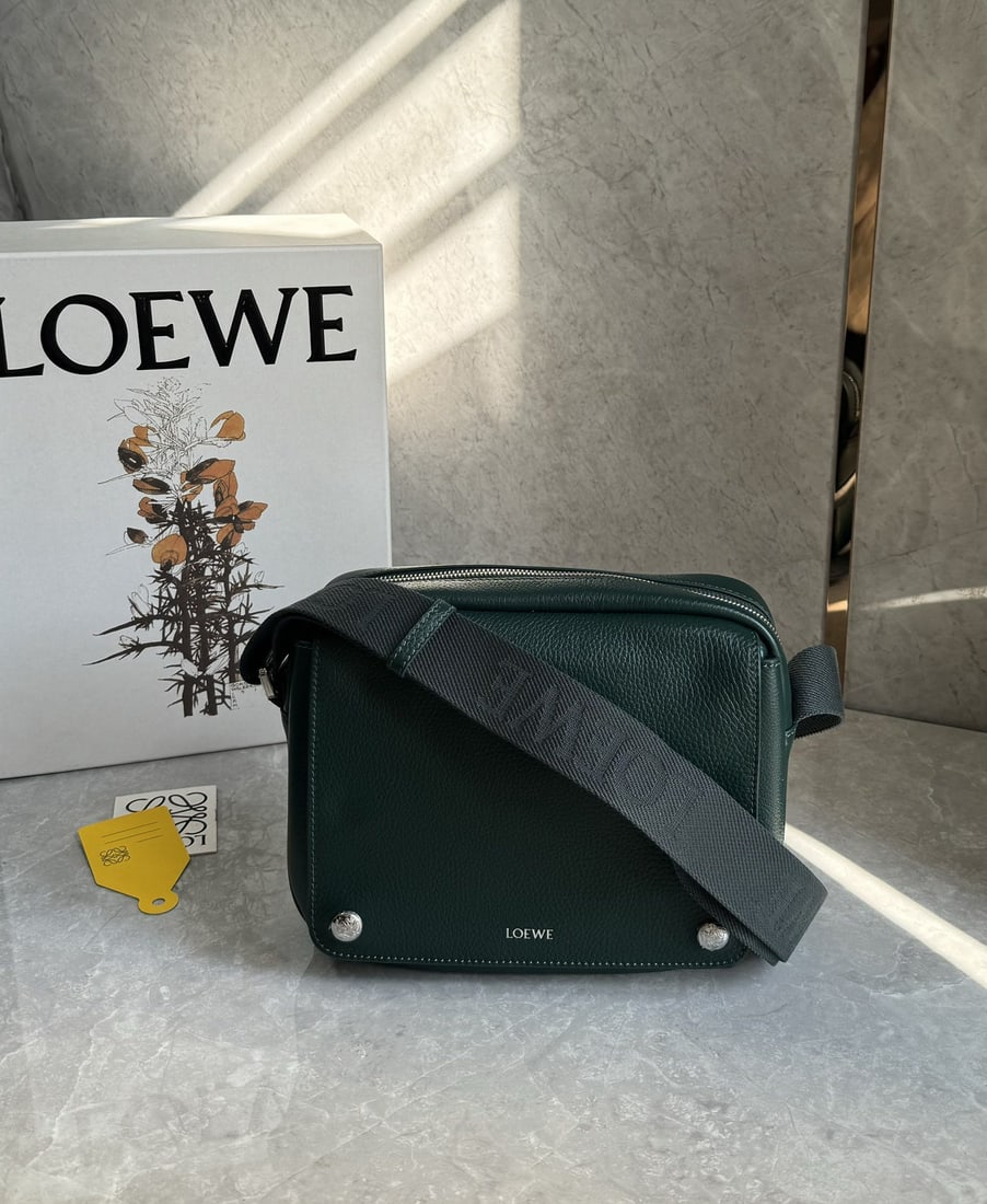LOEWE: We offer FREE SHIPPING for both domestic and international clients who bid over $500. The LOEWE Pebble messenger bag is crafted from supple grained cowhide leather and features an adjustable LOEWE