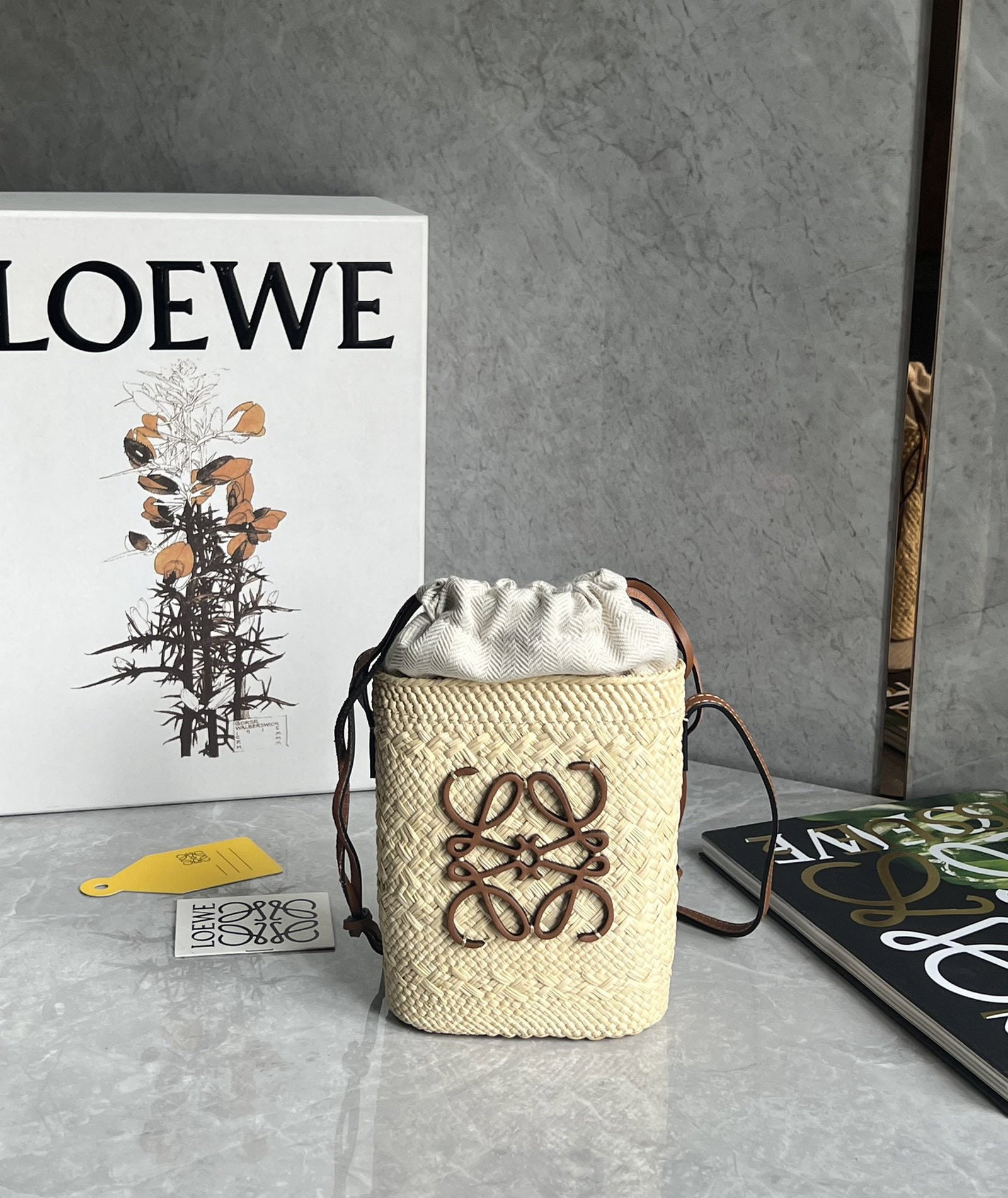 LOEWE: We offer FREE SHIPPING for both domestic and international clients who bid over $500. LOEWE Anagram Basket is made of handwoven raffia, offering ample capacity. It features a non-removable inner pouch