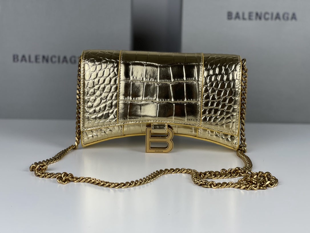 Balenciaga: We offer FREE SHIPPING for both domestic and international clients who bid over $500. This Balenciaga hourglass bag with a crocodile-embossed gold hardware and chain strap features a unique, iconic cu