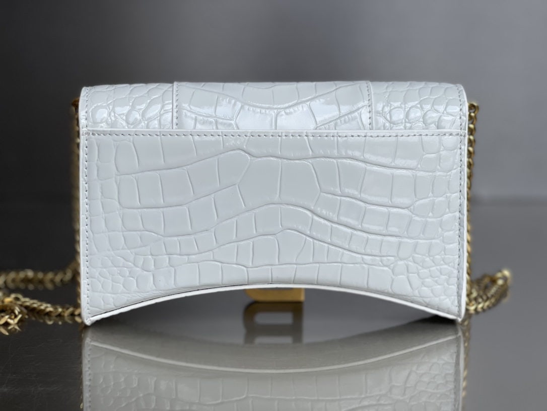 Balenciaga: We offer FREE SHIPPING for both domestic and international clients who bid over $500. The Balenciaga hourglass bag with crocodile platinum buckle and chain strap features a unique and iconic curved sh