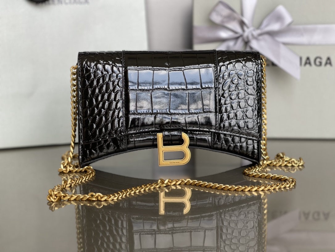 Balenciaga: We offer FREE SHIPPING for both domestic and international clients who bid over $500. The Balenciaga hourglass bag with crocodile gold hardware and chain strap features a unique and iconic curved shap