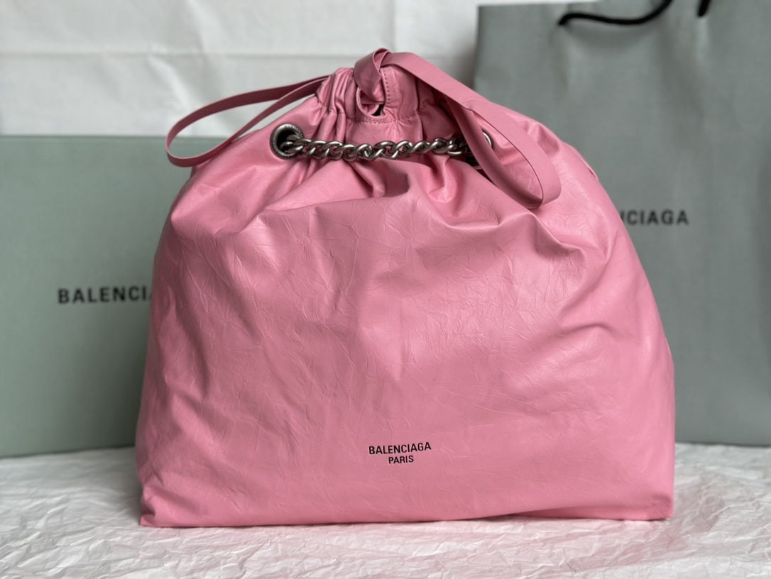 Balenciaga: We offer FREE SHIPPING for both domestic and international clients who bid over $500. This Balenciaga Crush Tote bag in a pleated pink is absolutely gorgeous! Made of glossy, pleated calfskin to