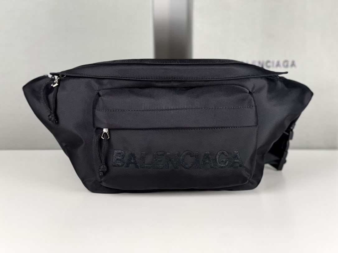 Balenciaga: We offer FREE SHIPPING for both domestic and international clients who bid over $500. Balenciaga canvas embroidered fanny pack in black with black lettering. Balenciaga has been incredibly popular the