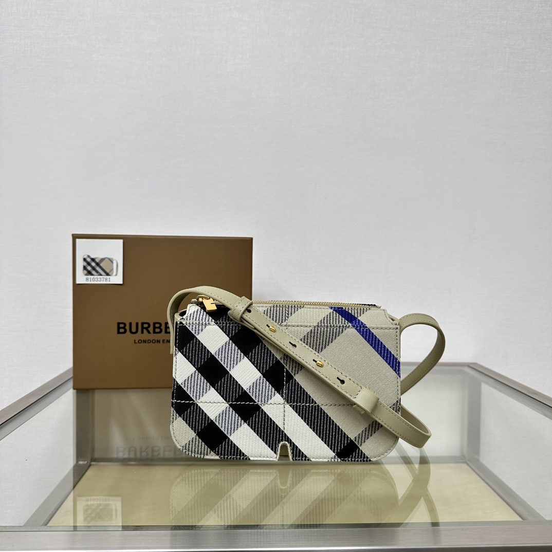 Burberry: We offer FREE SHIPPING for both domestic and international clients who bid over $500. This Burberry zip-up crossbody bag is crafted from a protective cotton blend. The decorative fine-spun Burberry ch