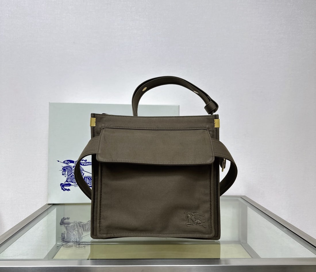 Burberry: We offer FREE SHIPPING for both domestic and international clients who bid over $500. This small Burberry trench coat tote bag is crafted from a cotton blend inspired by Burberry's iconic trench coat.
