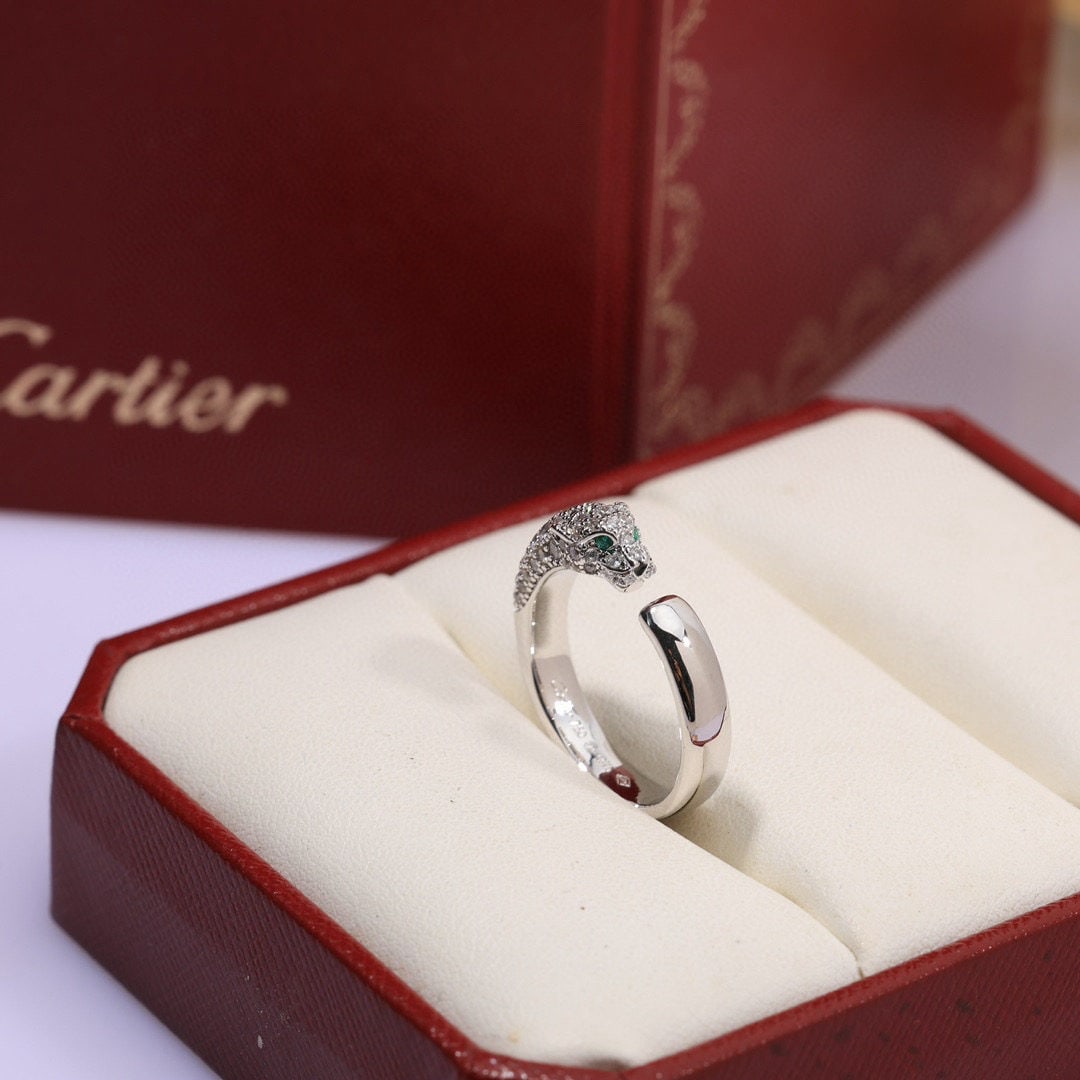 Cartier ring: We offer FREE SHIPPING for both domestic and international clients who bid over $500. A bold panther ring from Cartier, featuring an open panther design! Round brilliant-cut diamonds, emeralds, and on