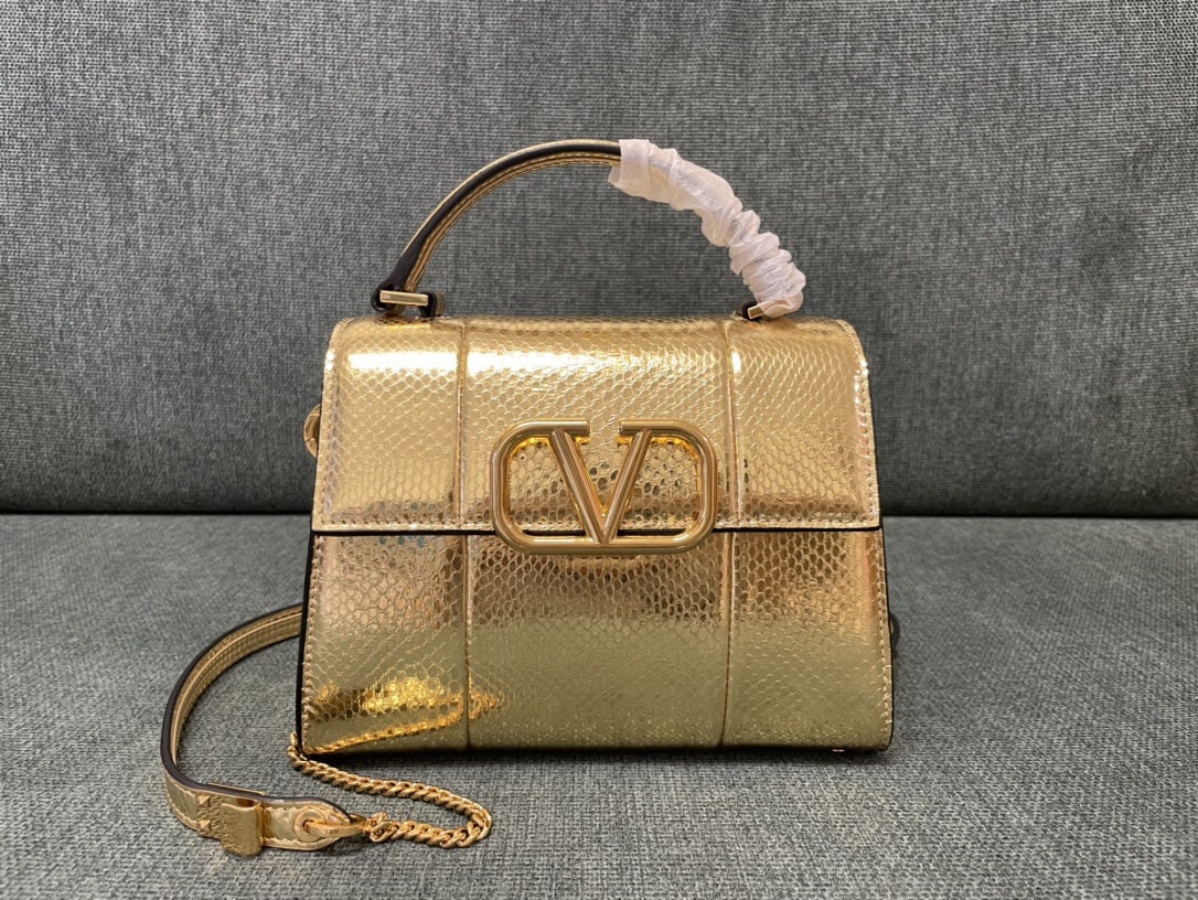 Valentino Garavani VSLING: We offer FREE SHIPPING for both domestic and international clients who bid over $500. The Valentino Garavani VSLING mini briefcase features an extendable two-tone shoulder strap and handle, allowing f