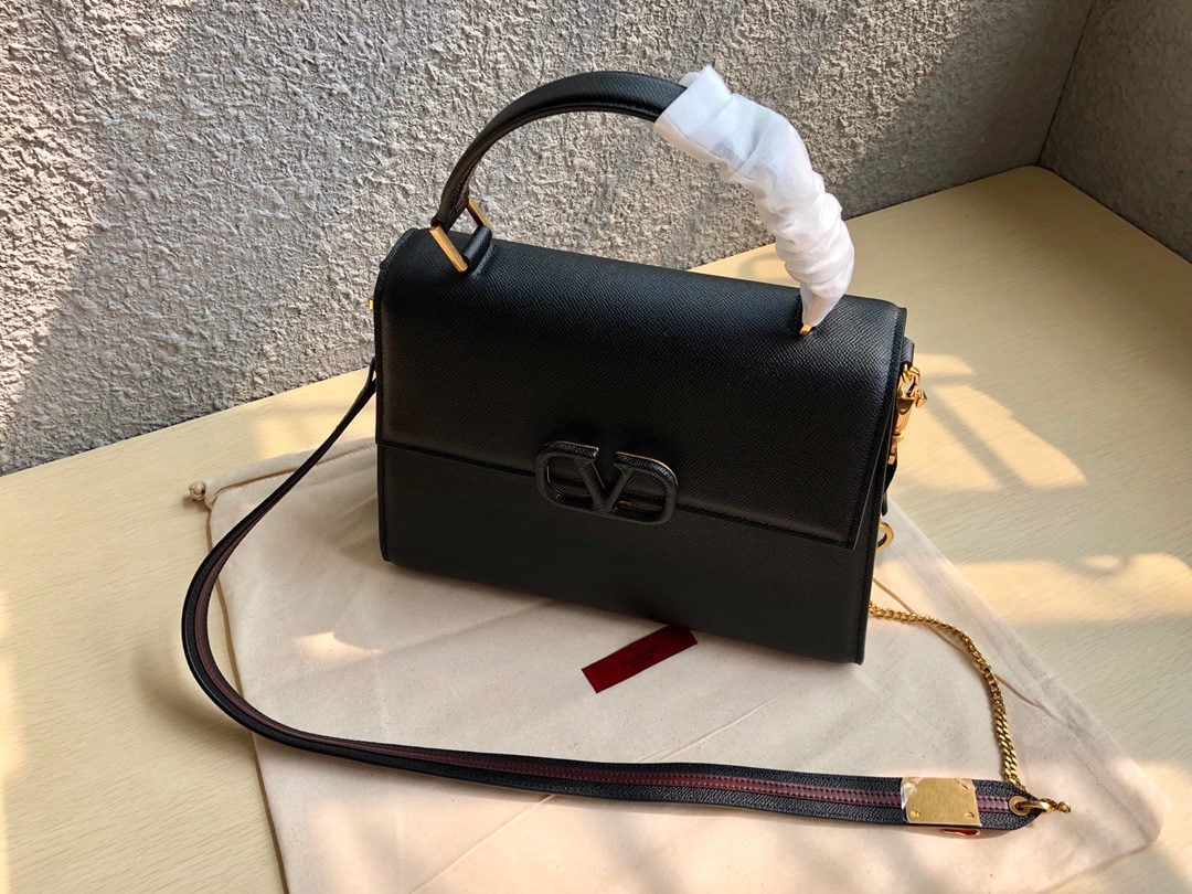 Valentino Garavani VSLING: We offer FREE SHIPPING for both domestic and international clients who bid over $500. The Valentino Garavani VSLING briefcase features a palm print design and comes with an extendable two-tone shoulde