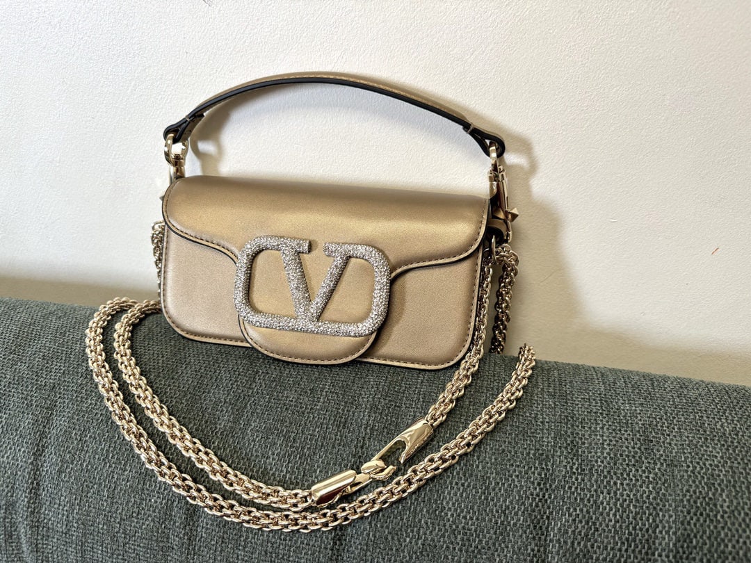 Valentino: We offer FREE SHIPPING for both domestic and international clients who bid over $500. Valentino calfskin handbag with star-studded buckle, featuring a vintage brass distressed finish, magnetic closure