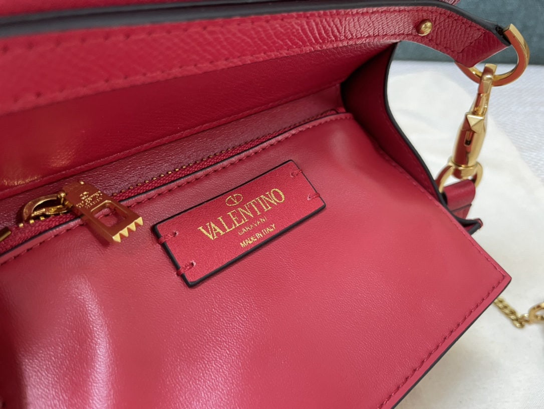 Valentino Garavani VSLING: We offer FREE SHIPPING for both domestic and international clients who bid over $500. This bright red mini Valentino Garavani VSLING briefcase features a palm print design and comes with an extendable