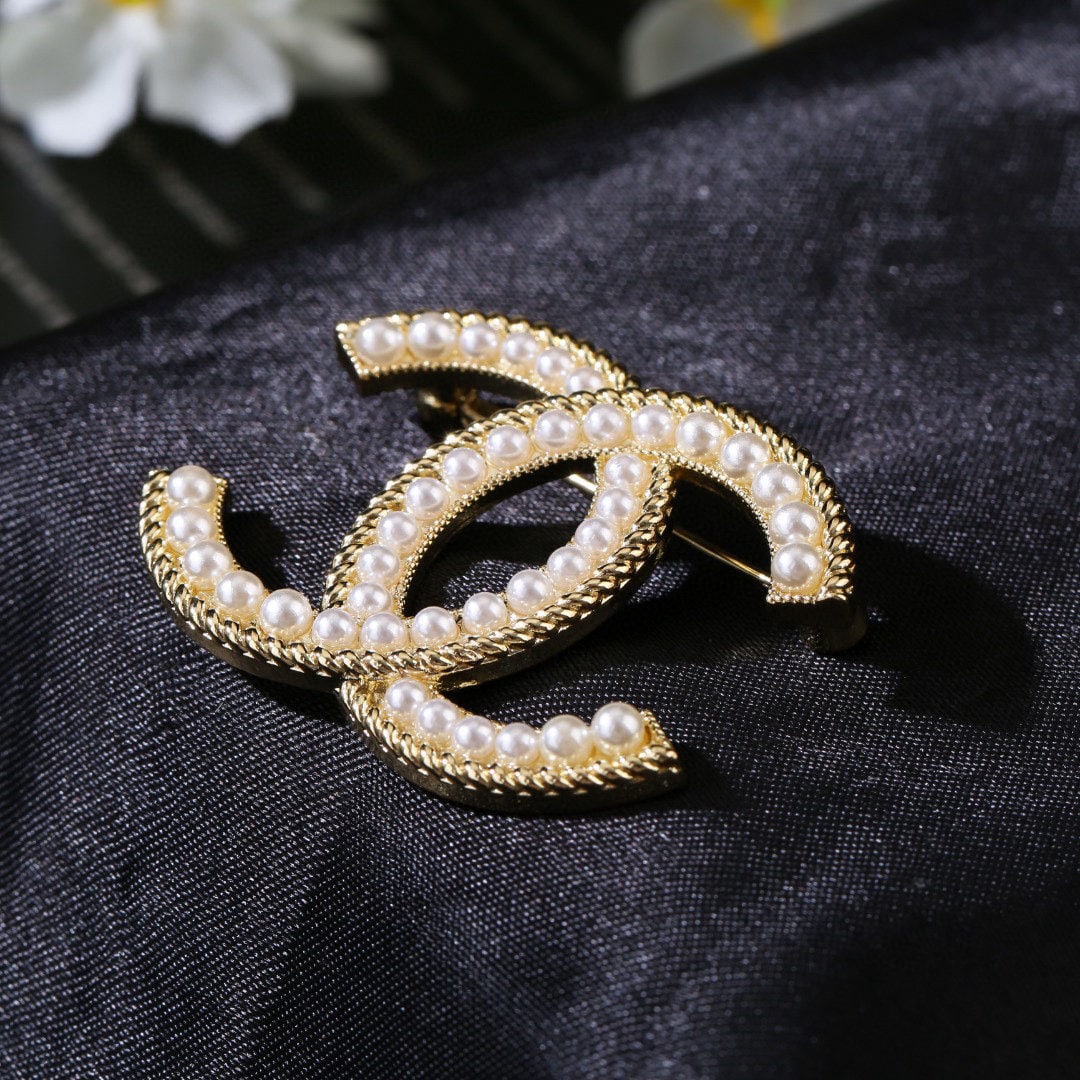 Chanel Fall/Winter Pearl Double C Brooch: We offer FREE SHIPPING for both domestic and international clients who bid over $500. Chanel's Fall/Winter pearl double C brooch is a subtly stylish and perfectly designed piece. A wonderful gift for 