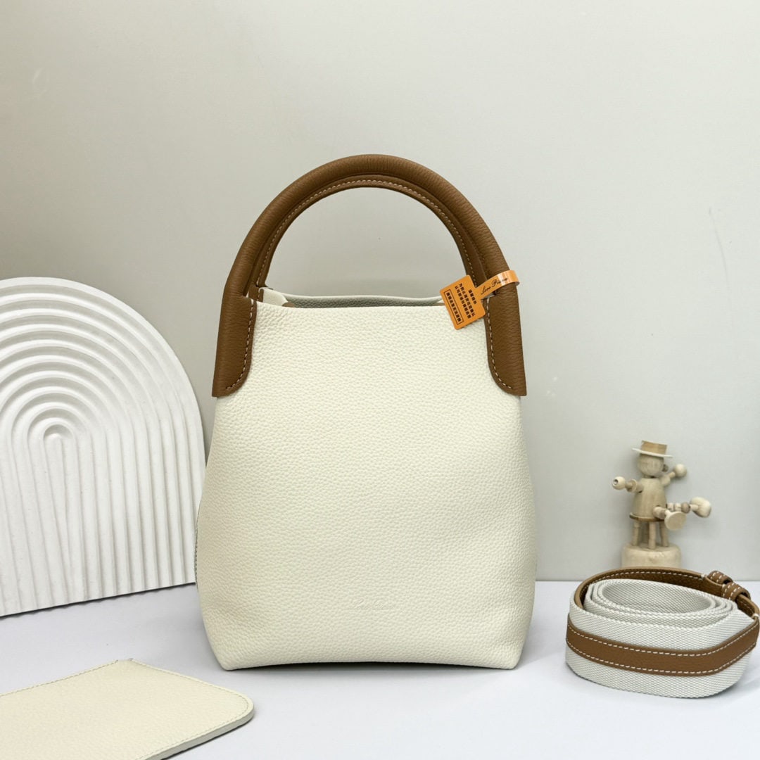 Loro piana Bale Medium Bucket Bag: We offer FREE SHIPPING for both domestic and international clients who bid over $500. The Loro Piana Bale Medium Bucket Bag in white and brown is crafted from premium calfskin leather with a suede lin