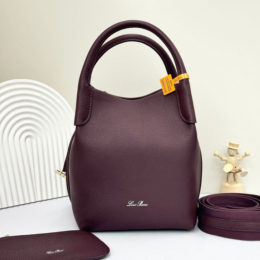 Loro piana Bale Medium Bucket Bag: We offer FREE SHIPPING for both domestic and international clients who bid over $500. The Loro Piana Bale Medium Bucket Bag in a red bean color is crafted from premium calfskin leather with a suede li