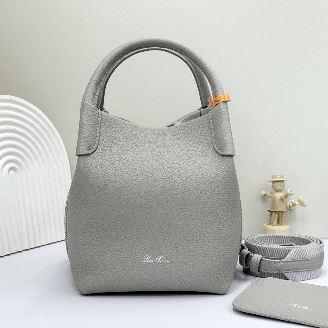 Loro piana Bale Medium Bucket Bag: We offer FREE SHIPPING for both domestic and international clients who bid over $500. The Loro Piana Bale Medium Bucket Bag in Dusty Stone Grey is crafted from premium calfskin leather with a suede li